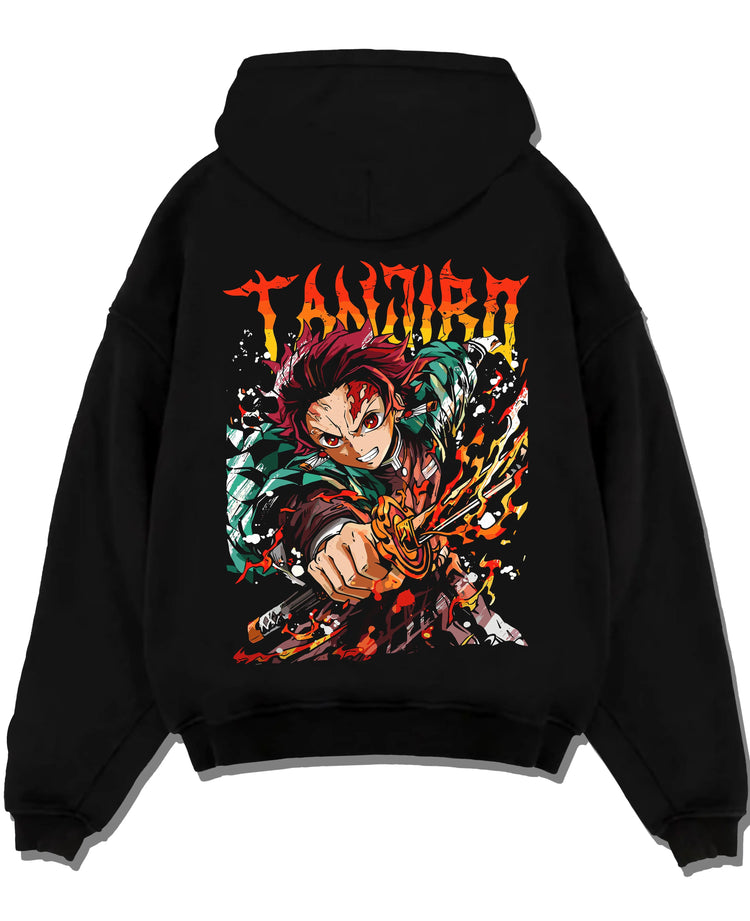 Black hoodie laid flat featuring Tanjiro Kamado flame sword Hinokami battle Demon Slayer artwork.