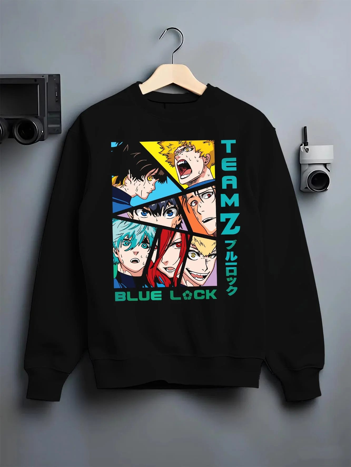 Black crewneck sweatshirt on hanger with Blue Lock Hoodie Team Z Isagi Bachira Soccer Squad graphic bold anime graphic.