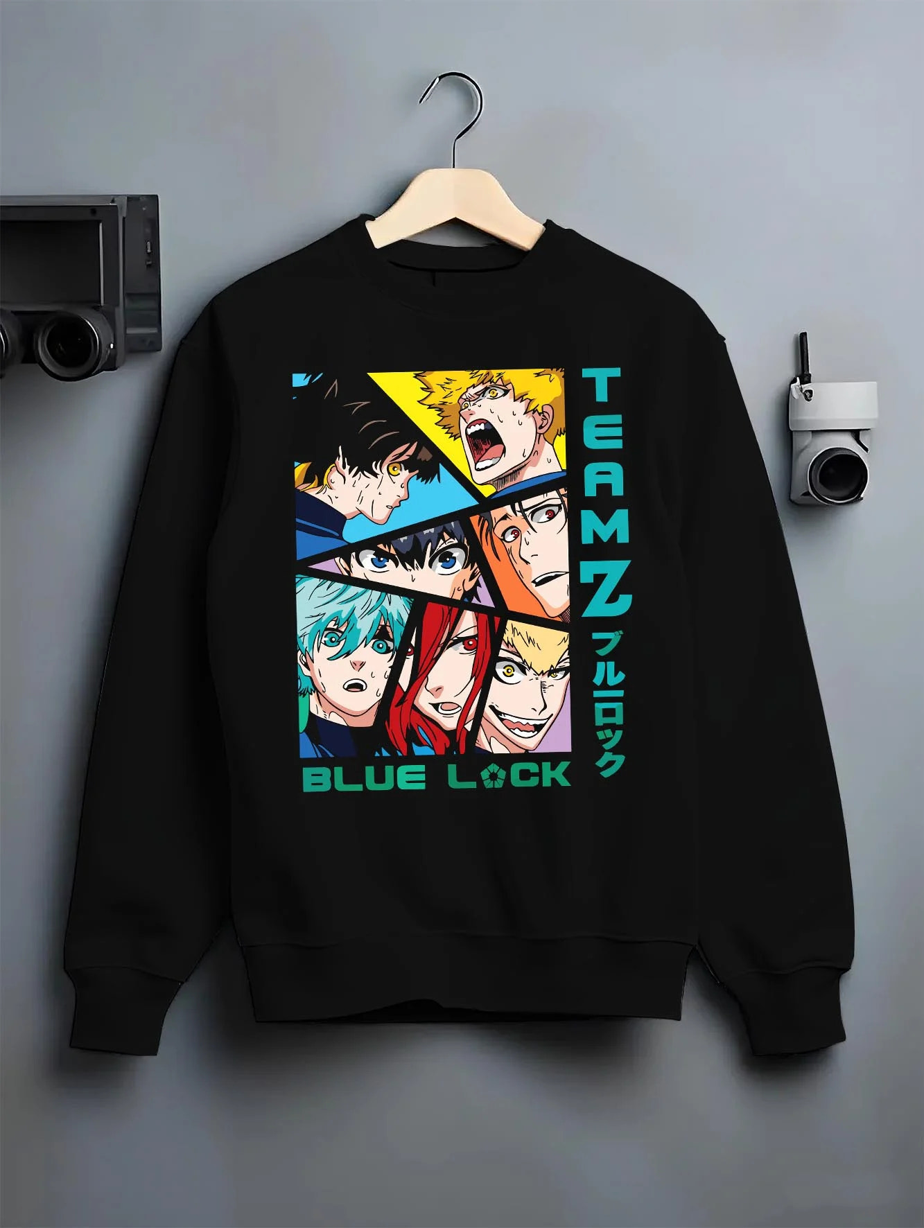 Black crewneck sweatshirt on hanger with Blue Lock Hoodie Team Z Isagi Bachira Soccer Squad graphic bold anime graphic.