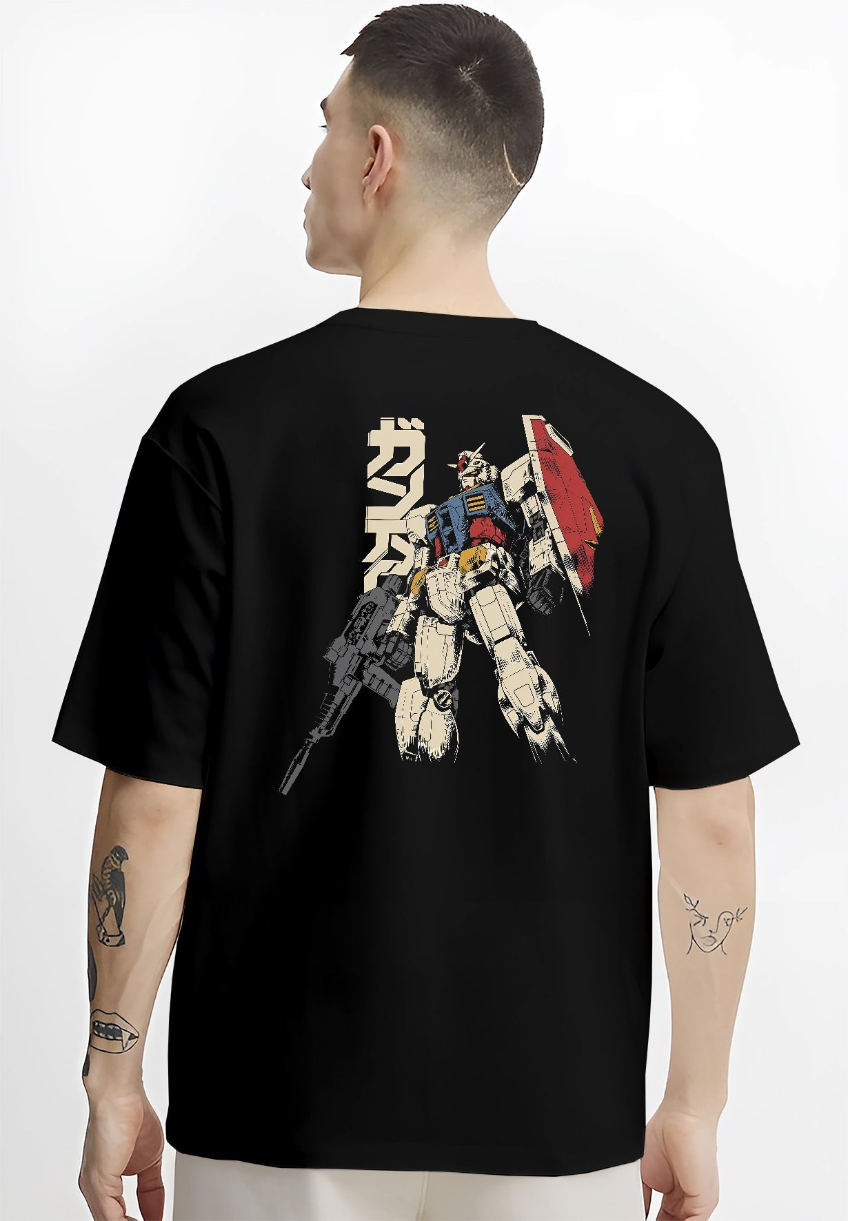 Black T-shirt worn by a male model, back view, featuring Mobile Suit Gundam anime poster inspired retro manga artwork print with detailed giant mecha design.