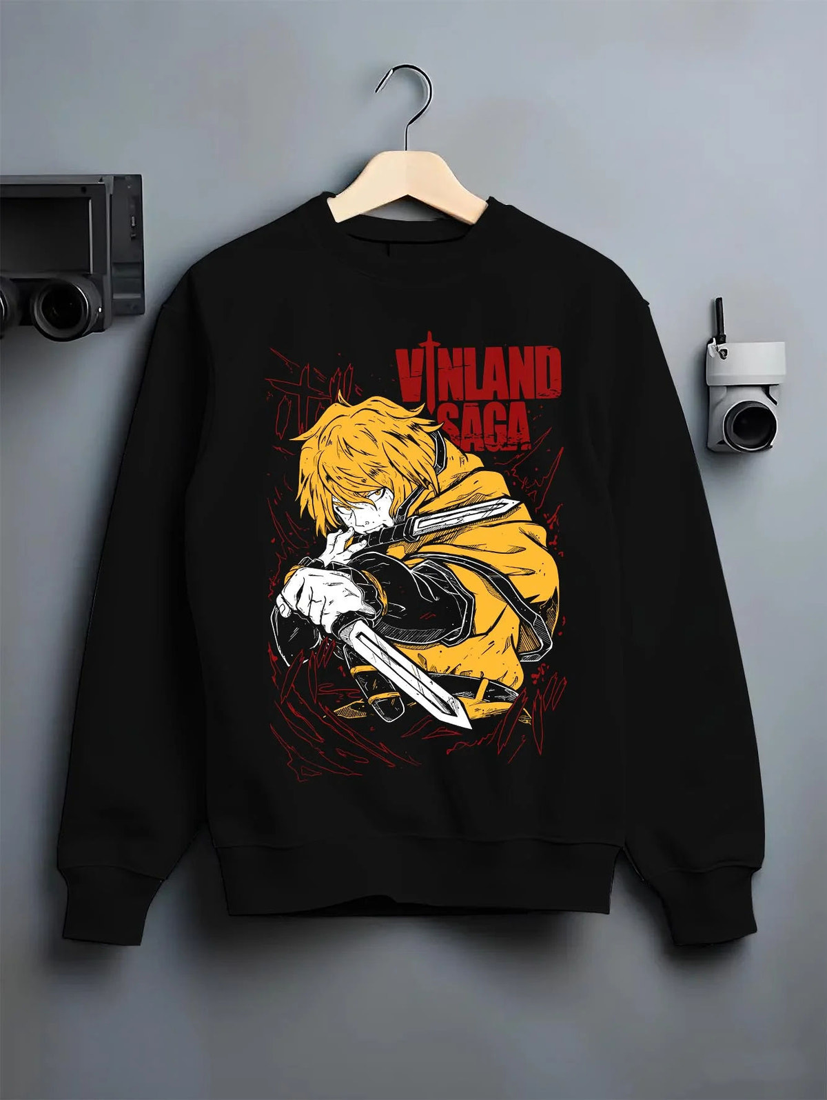 Black crewneck sweatshirt on hanger featuring Thorfinn Viking warrior dual blades Vinland Saga artwork.