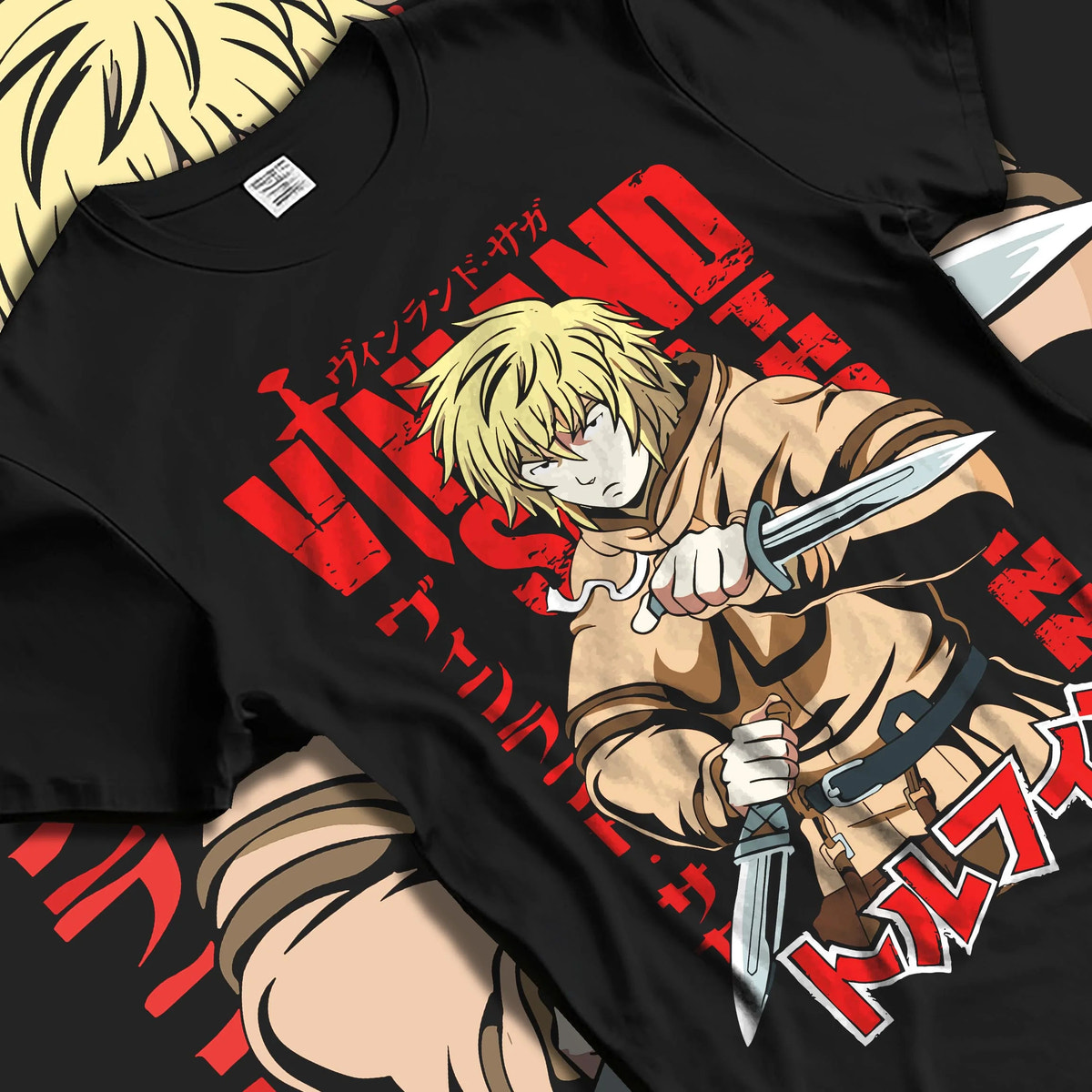 Black T-shirt laid flat with natural folds featuring Thorfinn dual daggers Viking warrior Vinland Saga artwork.
