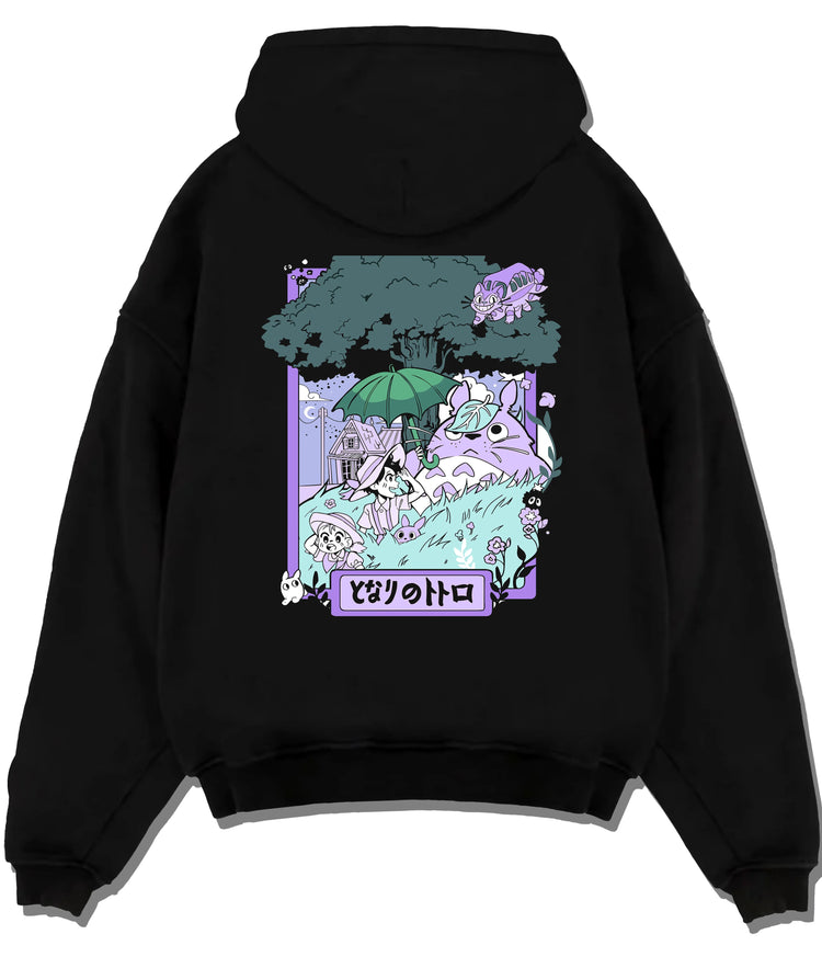 Black hoodie flat back view showing Totoro and friends from My Neighbour Totoro: pastel forest scene