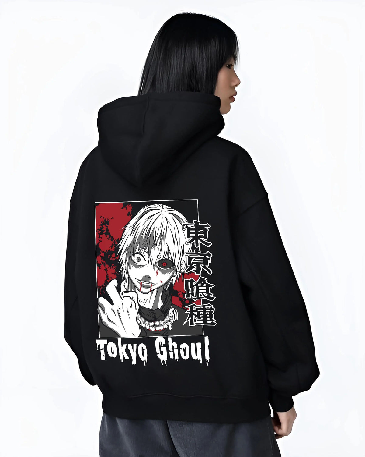 Black hoodie worn by female model from the back featuring Ken Kaneki One-Eyed Ghoul mask portrait Tokyo Ghoul artwork.