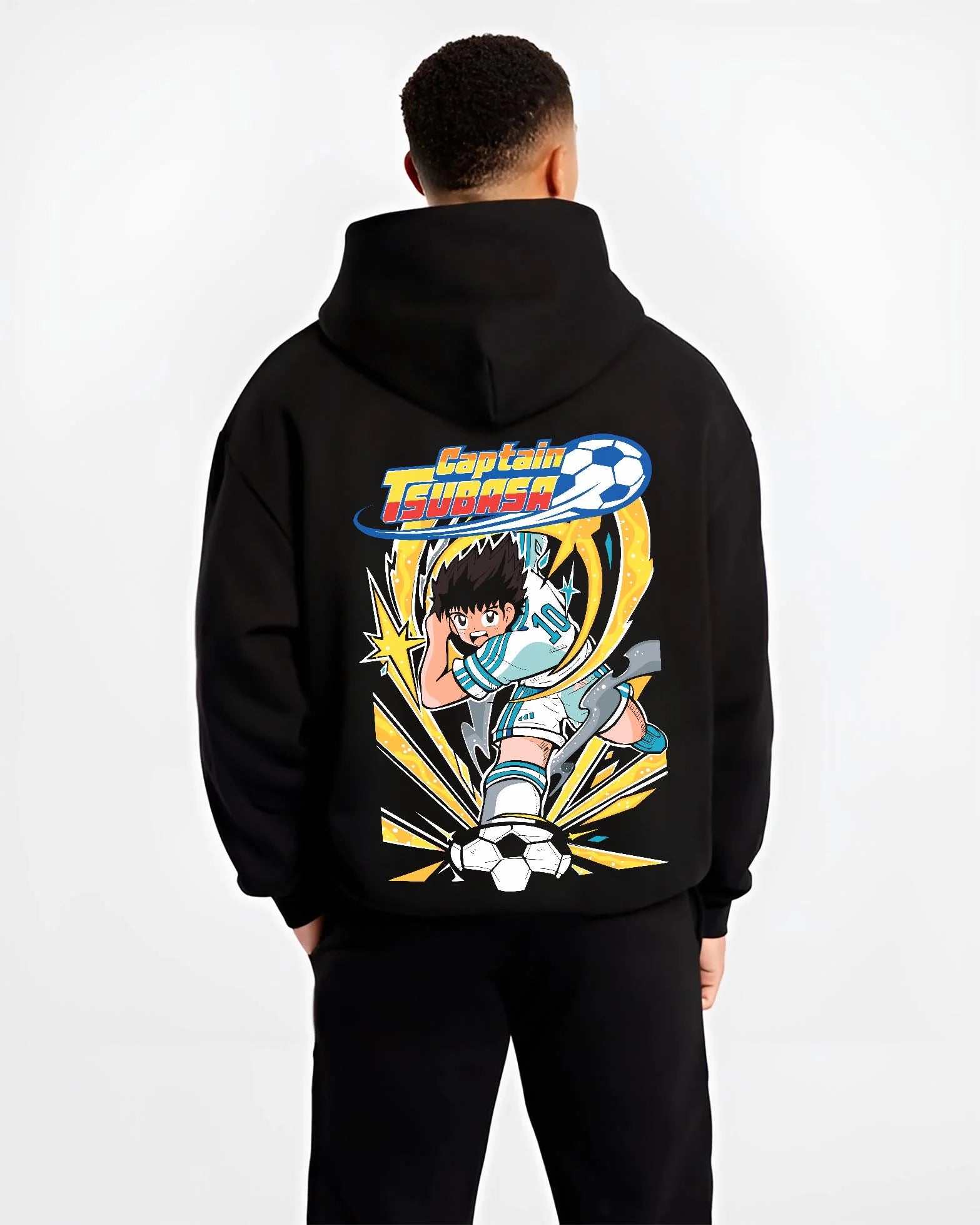 Black hoodie worn by male model, back view with Tsubasa Hoodie Captain Tsubasa Soccer Kick Classic graphic streetwear graphic.