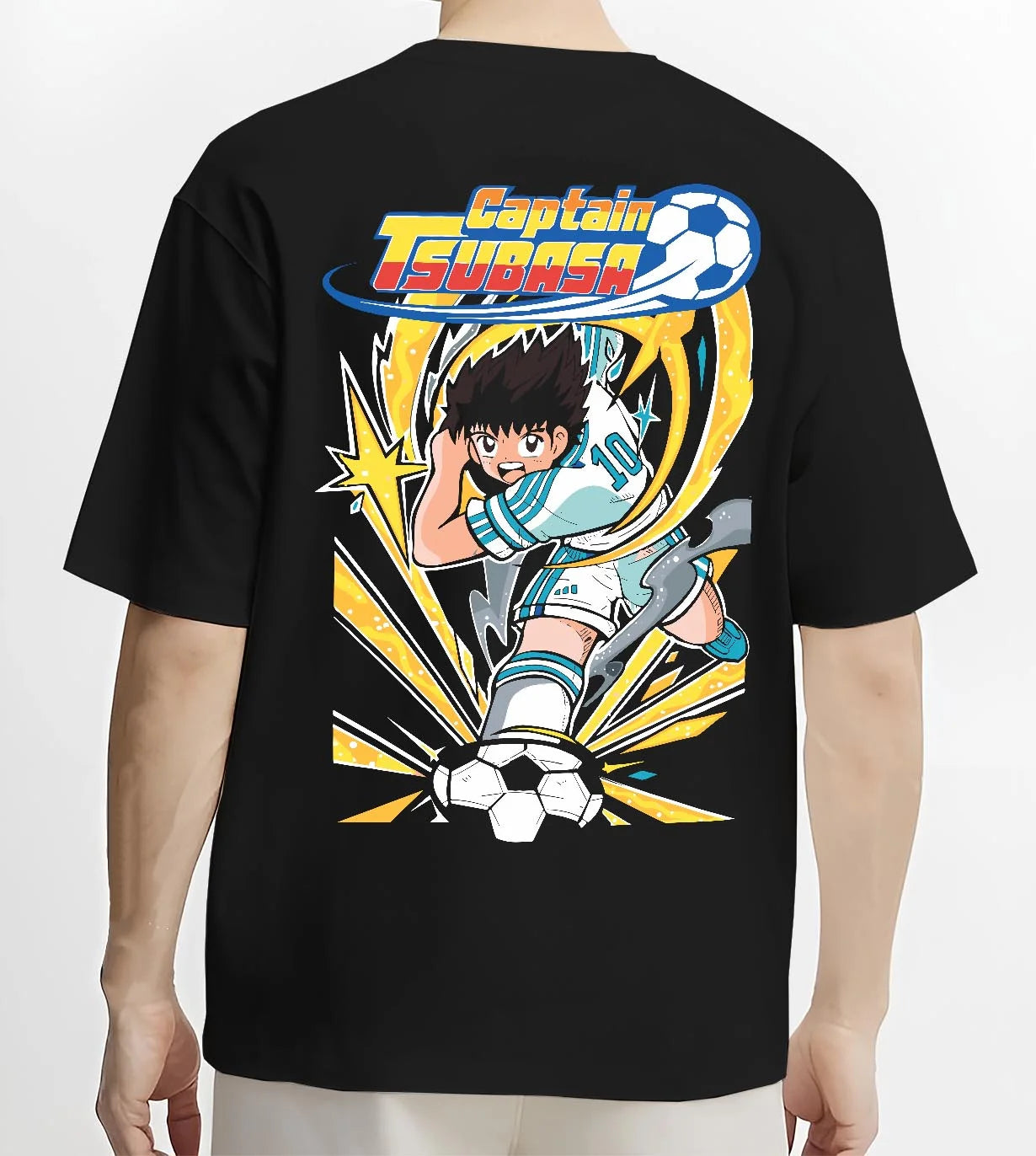 Black T-shirt worn by male model, back view with Tsubasa Hoodie Captain Tsubasa Soccer Kick Classic graphic streetwear graphic.