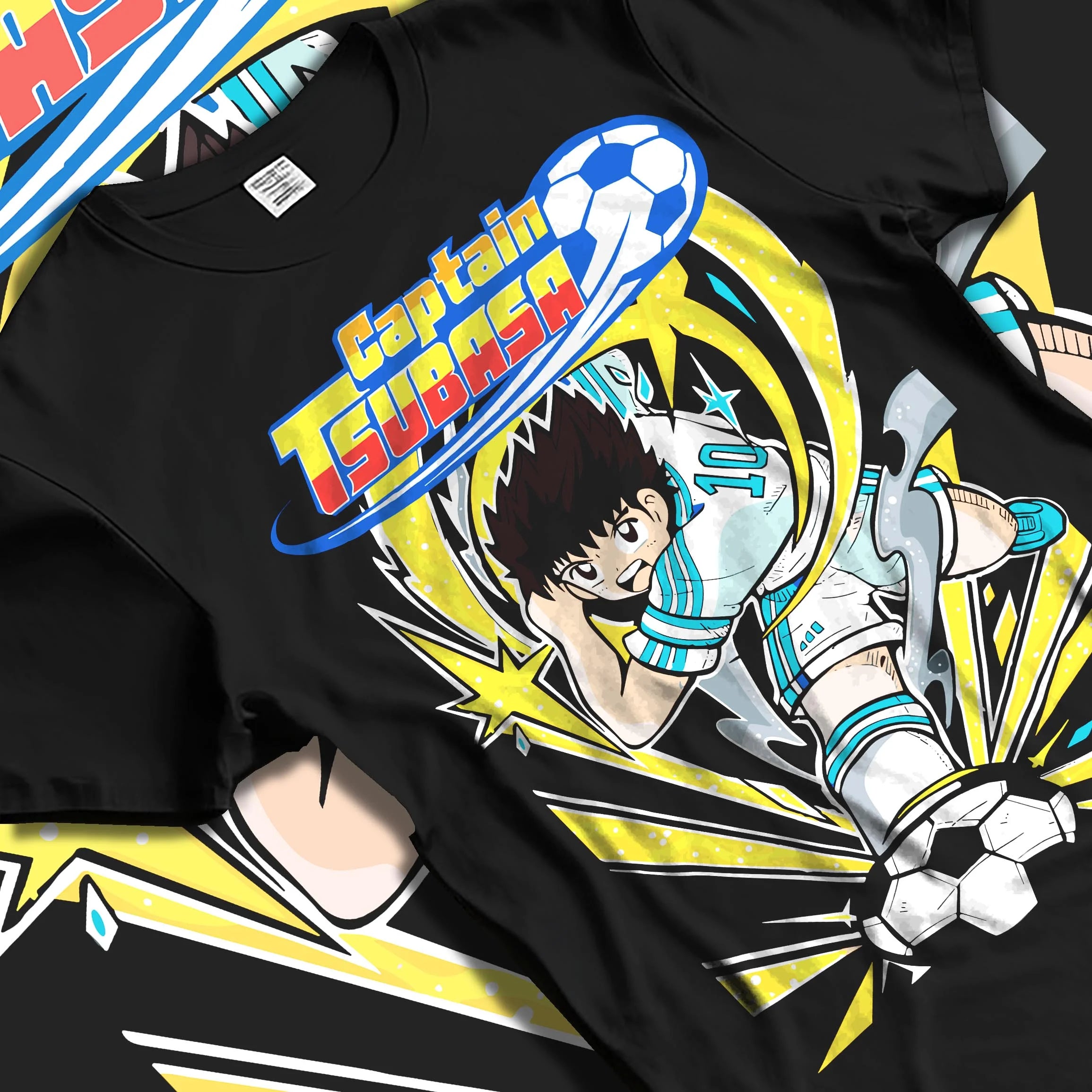 Black T-shirt laid flat with natural folds with Tsubasa Hoodie Captain Tsubasa Soccer Kick Classic graphic bold anime graphic.