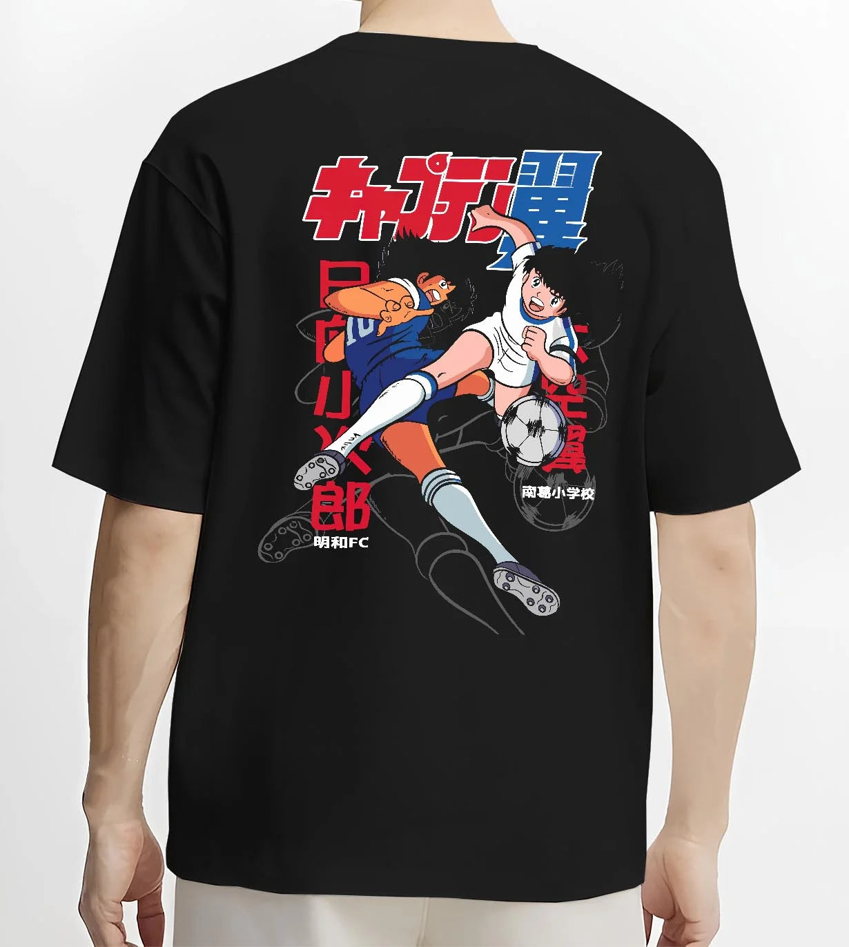Black T-shirt worn by male model, back view with Tsubasa Duo Hoodie Captain Tsubasa Soccer Team Play graphic streetwear graphic.