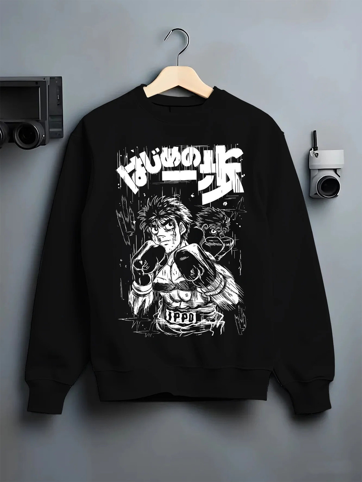 Black crewneck sweatshirt on hanger showing Ippo Makunouchi from Hajime no Ippo: monochrome boxing portrait