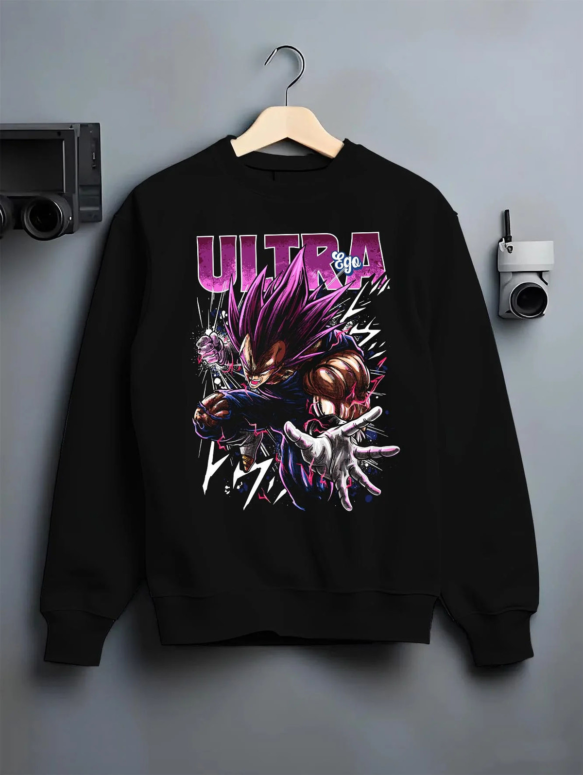 Black crewneck sweatshirt on hanger featuring Vegeta Ultra Ego purple battle power Dragon Ball Super artwork.