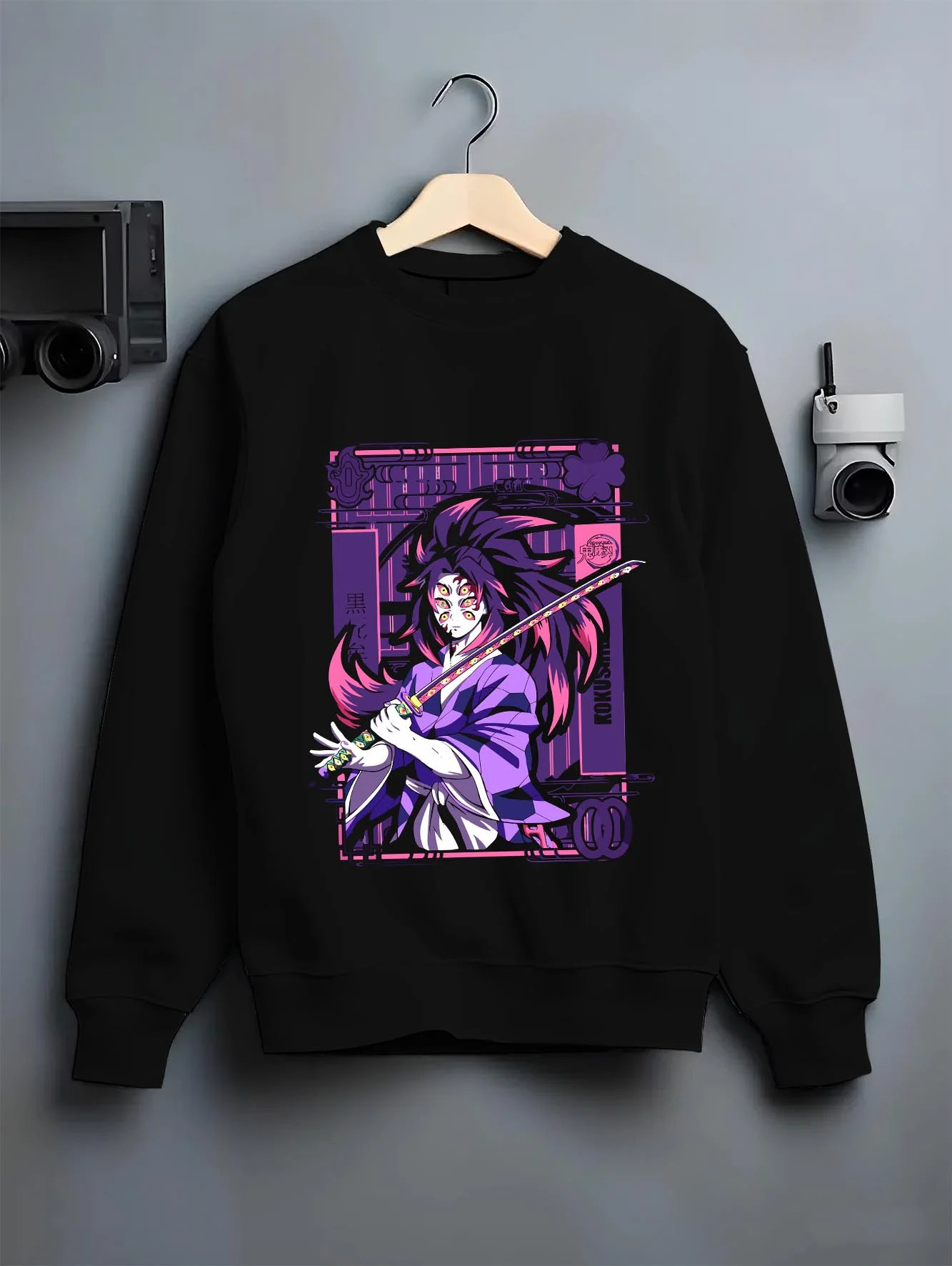 Black crewneck sweatshirt on hanger with Upper Moon Hoodie Demon Slayer Demonic Power graphic streetwear graphic.