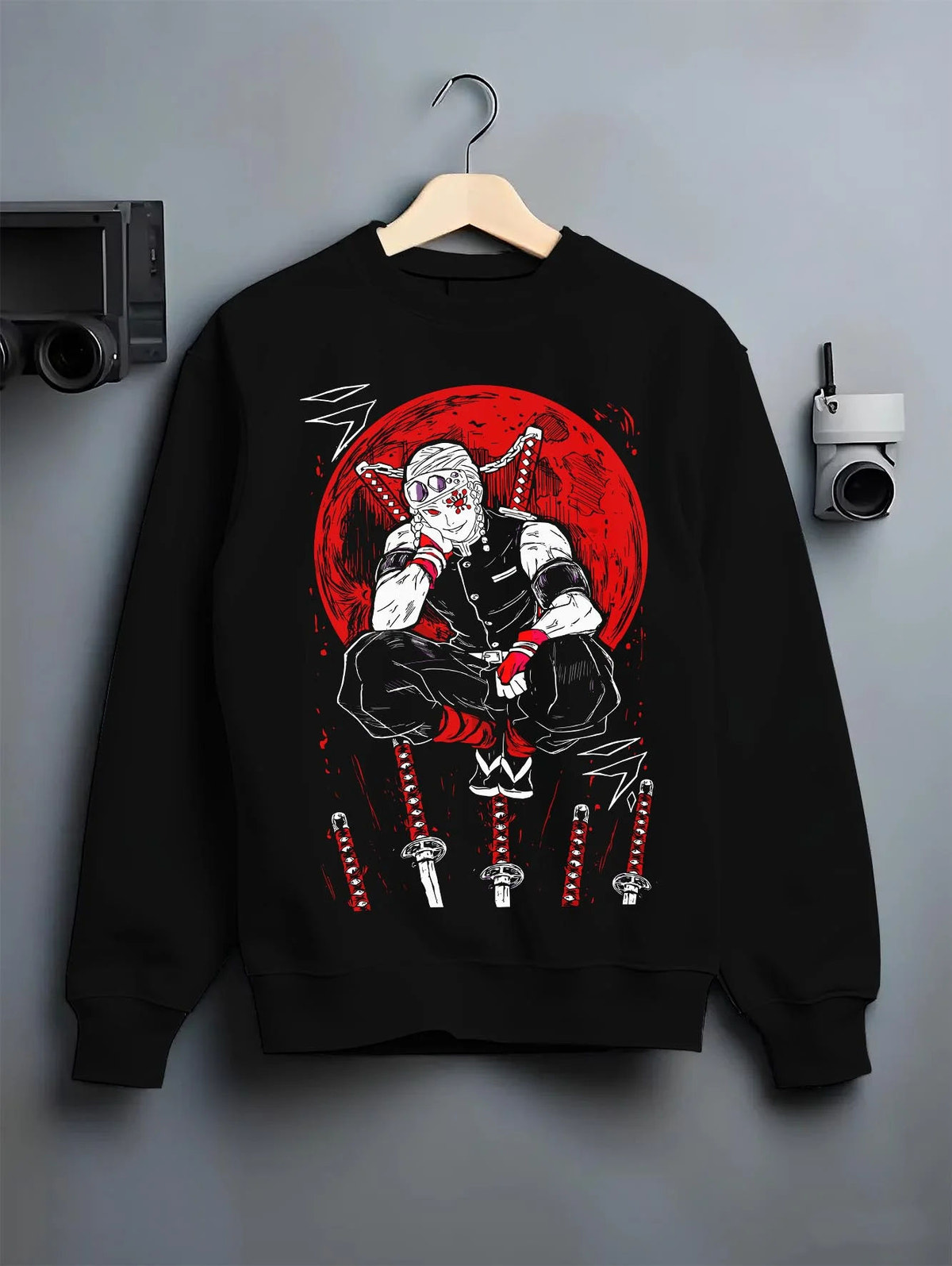 Black crewneck sweatshirt on hanger featuring Tengen Uzui Sound Hashira flame battle Demon Slayer artwork.