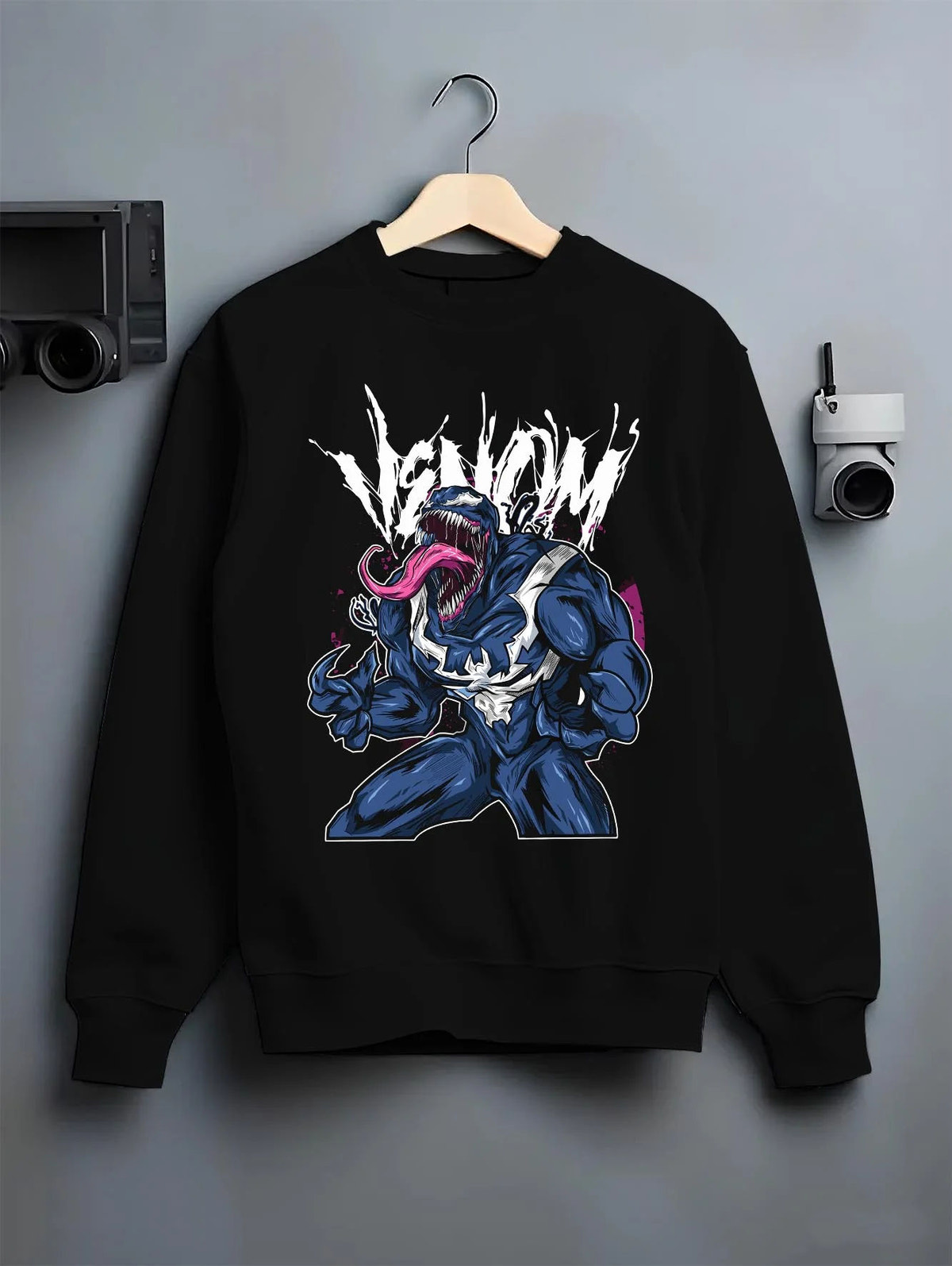 Black crewneck sweatshirt on hanger featuring Venom black symbiote Lethal Protector Marvel artwork.