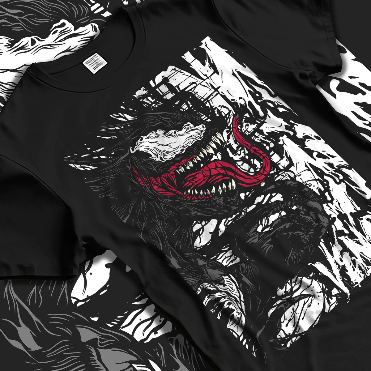 Black T-shirt laid flat with natural folds featuring Venom white symbiote monster portrait Marvel artwork.