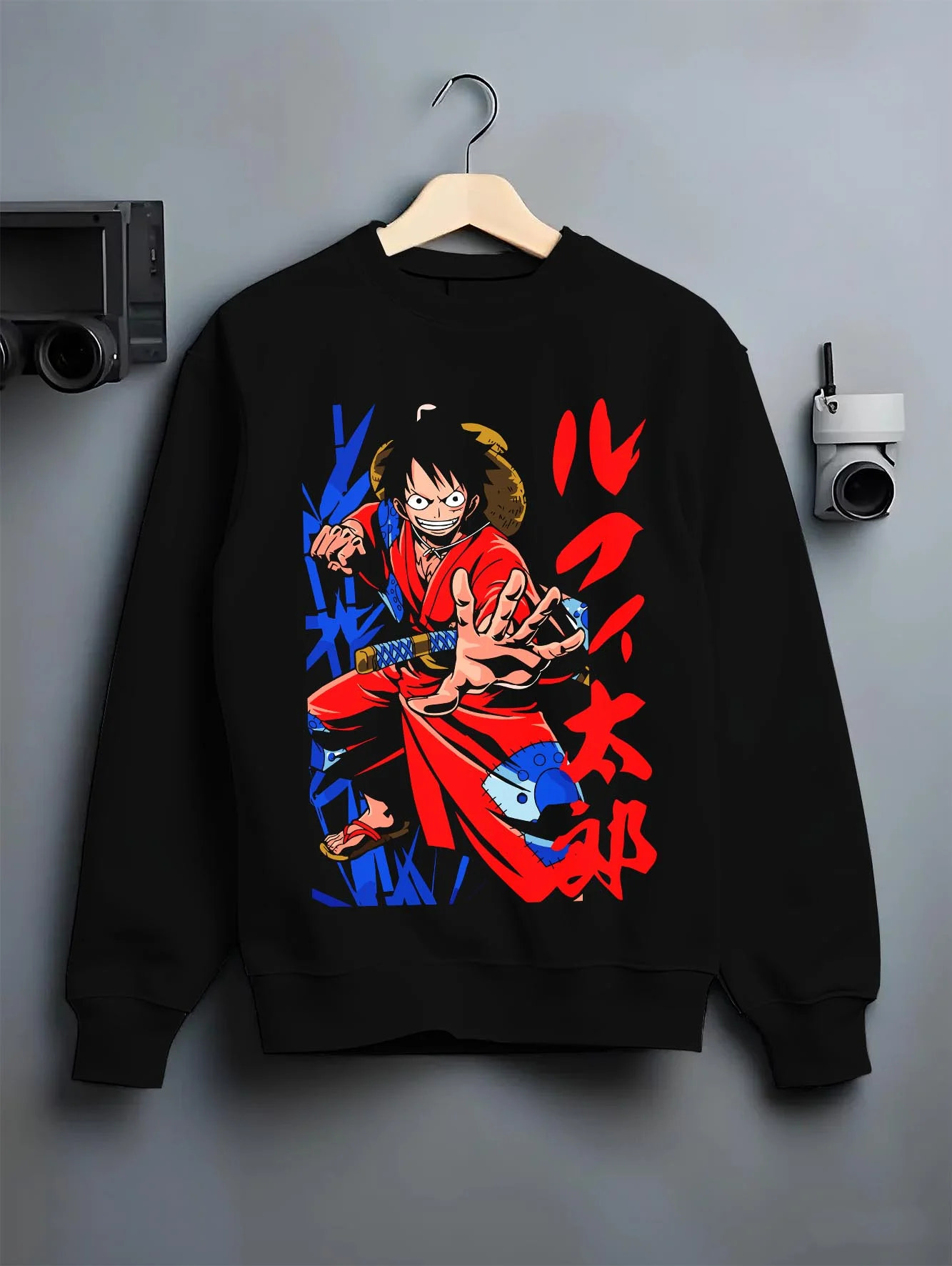Black crewneck sweatshirt on hanger with Monkey D Luffy Hoodie One Piece Samurai Warrior graphic streetwear graphic.