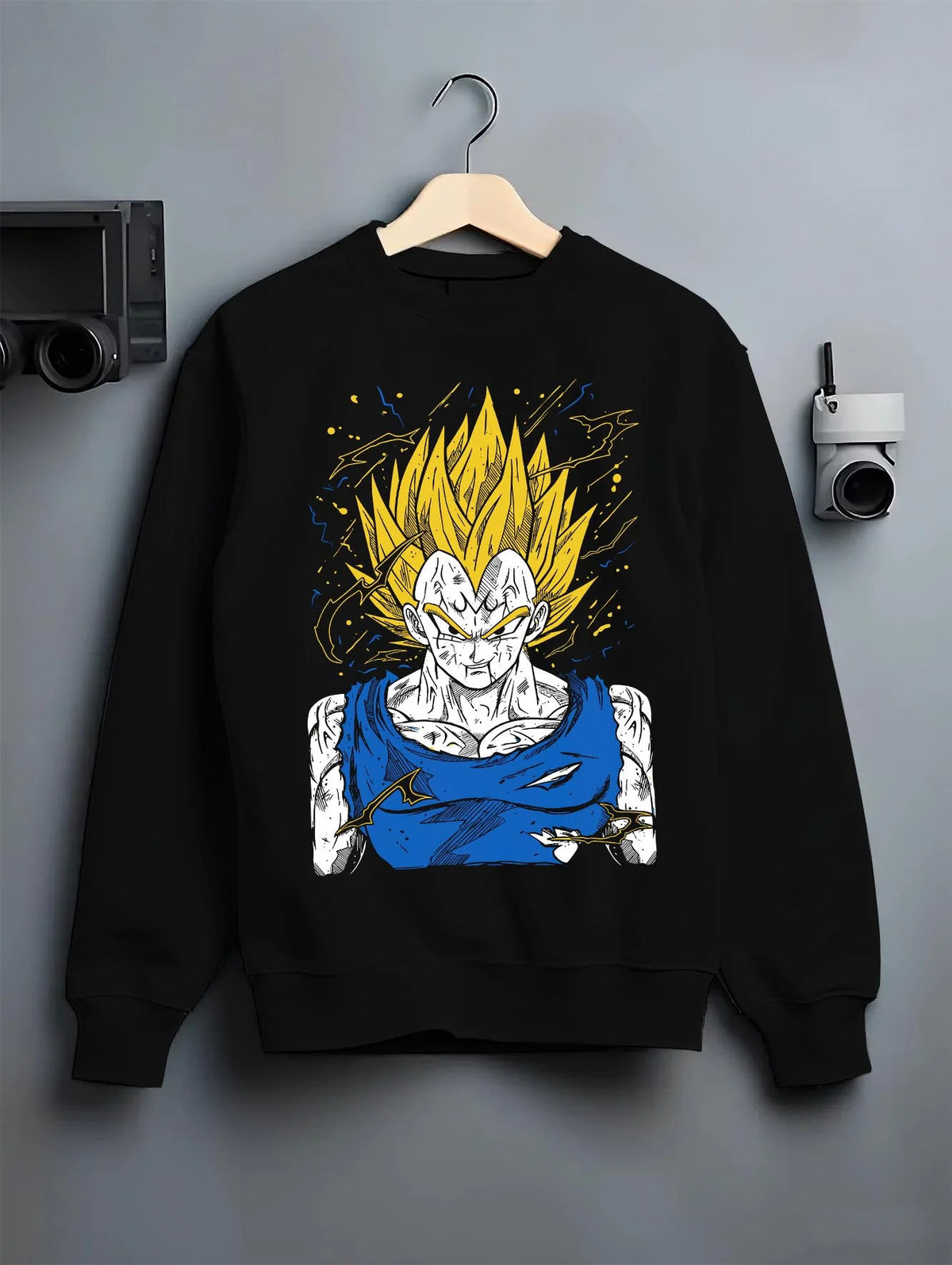 Black crewneck sweatshirt on hanger featuring Majin Vegeta battle-worn Saiyan Dragon Ball Z artwork.