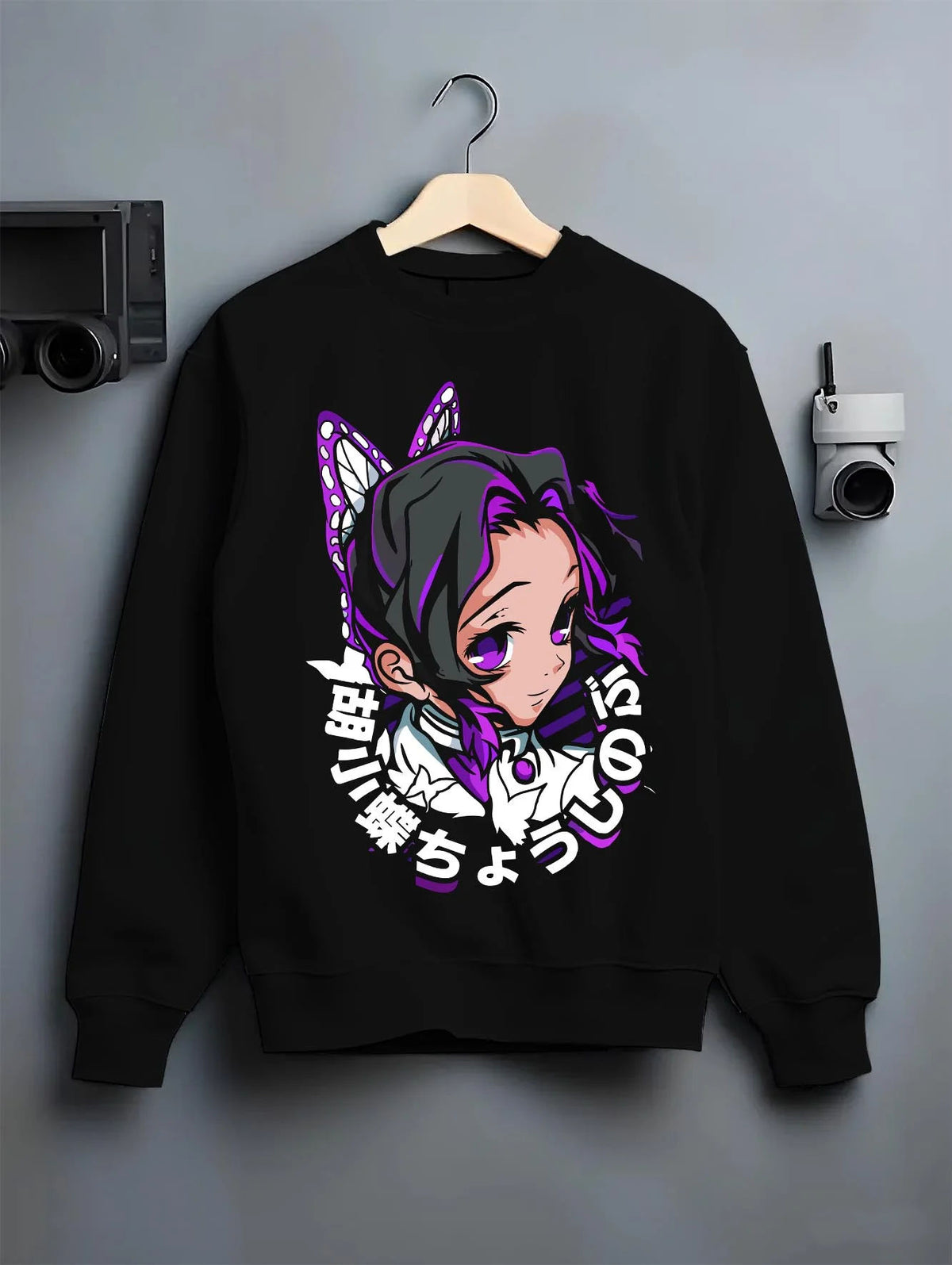 Black crewneck sweatshirt on hanger featuring Shinobu Kocho Butterfly Hashira portrait Demon Slayer artwork.