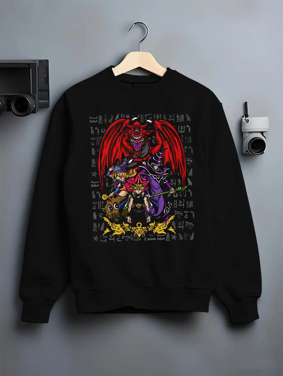 Black crewneck sweatshirt on hanger featuring Yugi Egyptian God Cards duel Yu-Gi-Oh! artwork.