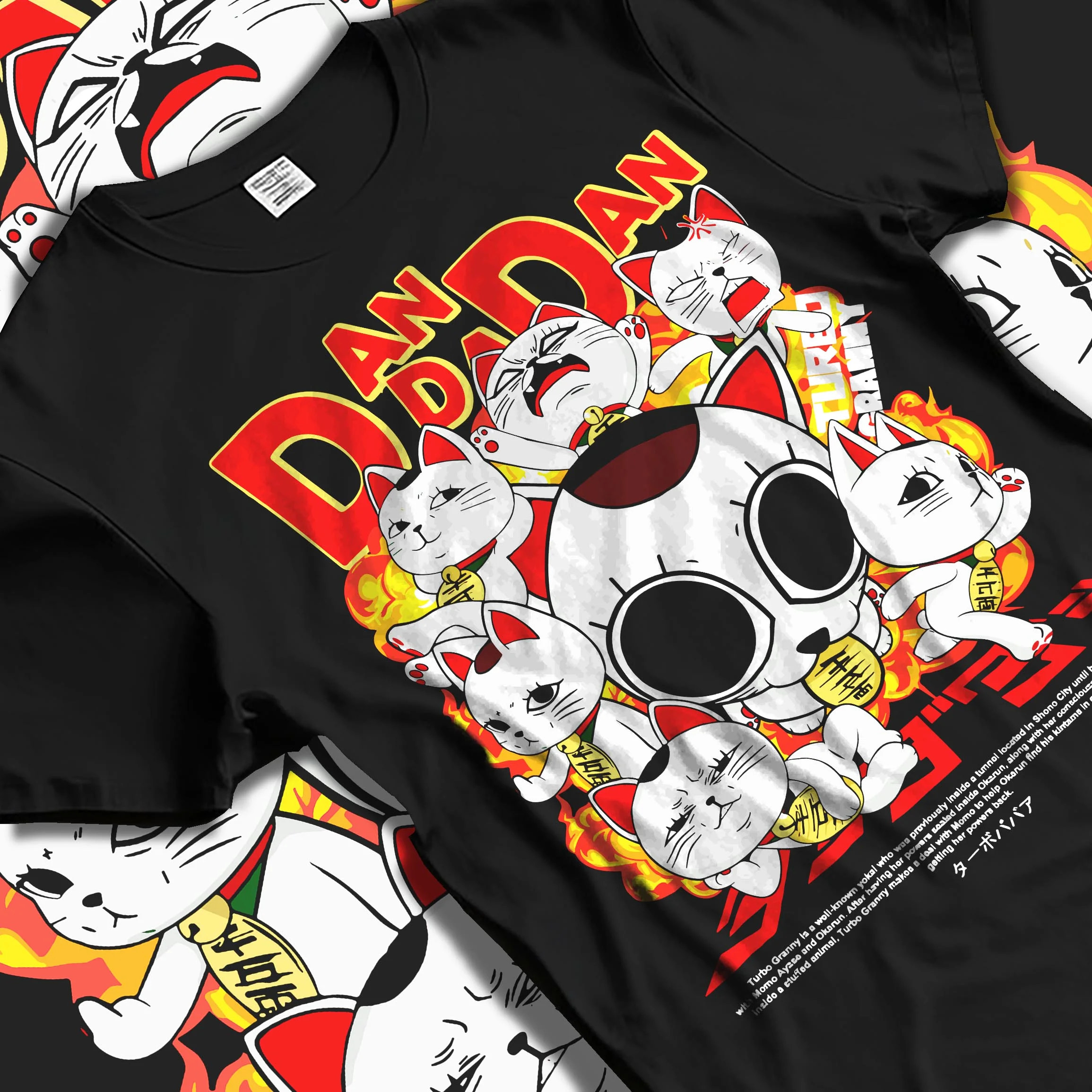 Black T-shirt laid flat with natural folds with Turbo Granny Hoodie Dandadan Lucky Cat Spirit Anime graphic premium wear.
