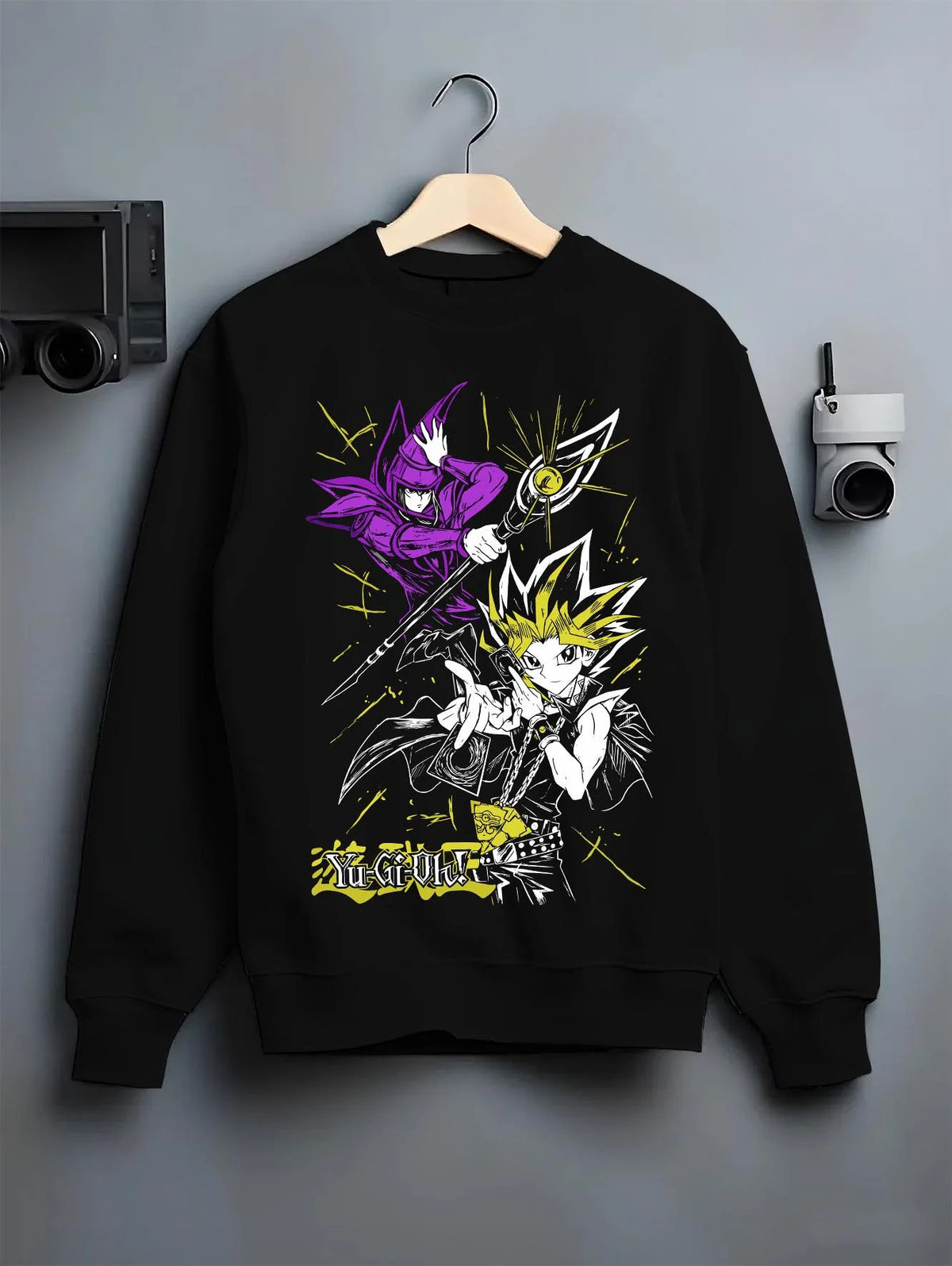 Black crewneck sweatshirt on hanger featuring Yugi Millennium Puzzle King of Games Yu-Gi-Oh! artwork.