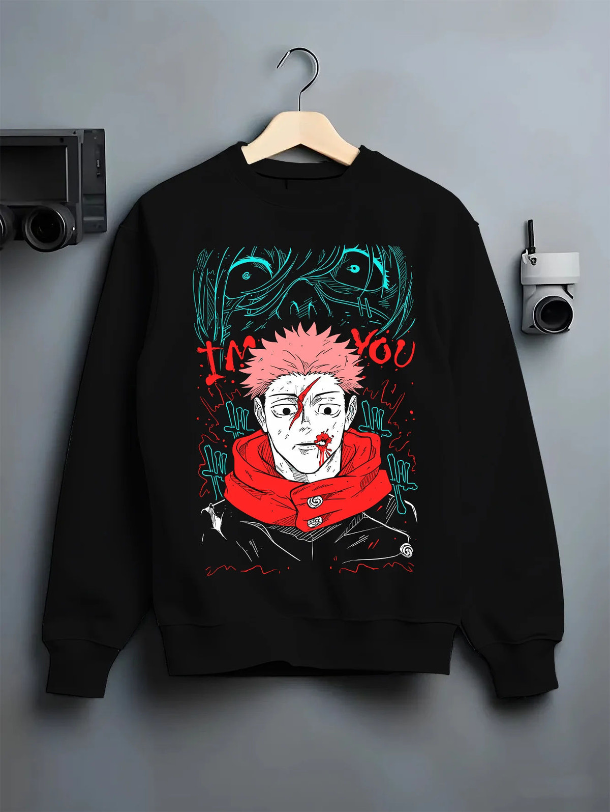 Black crewneck sweatshirt on hanger showing Yuji Itadori / Sukuna from Jujutsu Kaisen: scarred face red scarf artwork