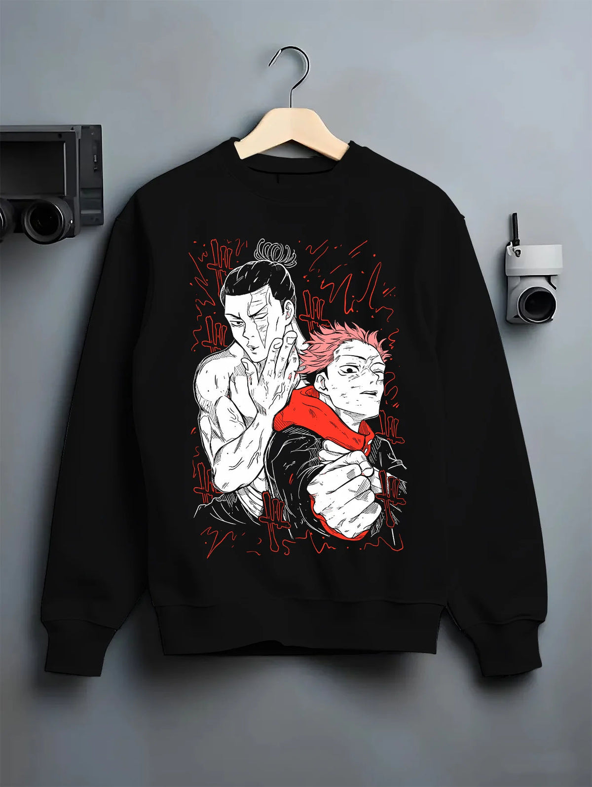 Black crewneck sweatshirt on hanger showing Yuji Itadori and teammate from Jujutsu Kaisen: fight scene illustration