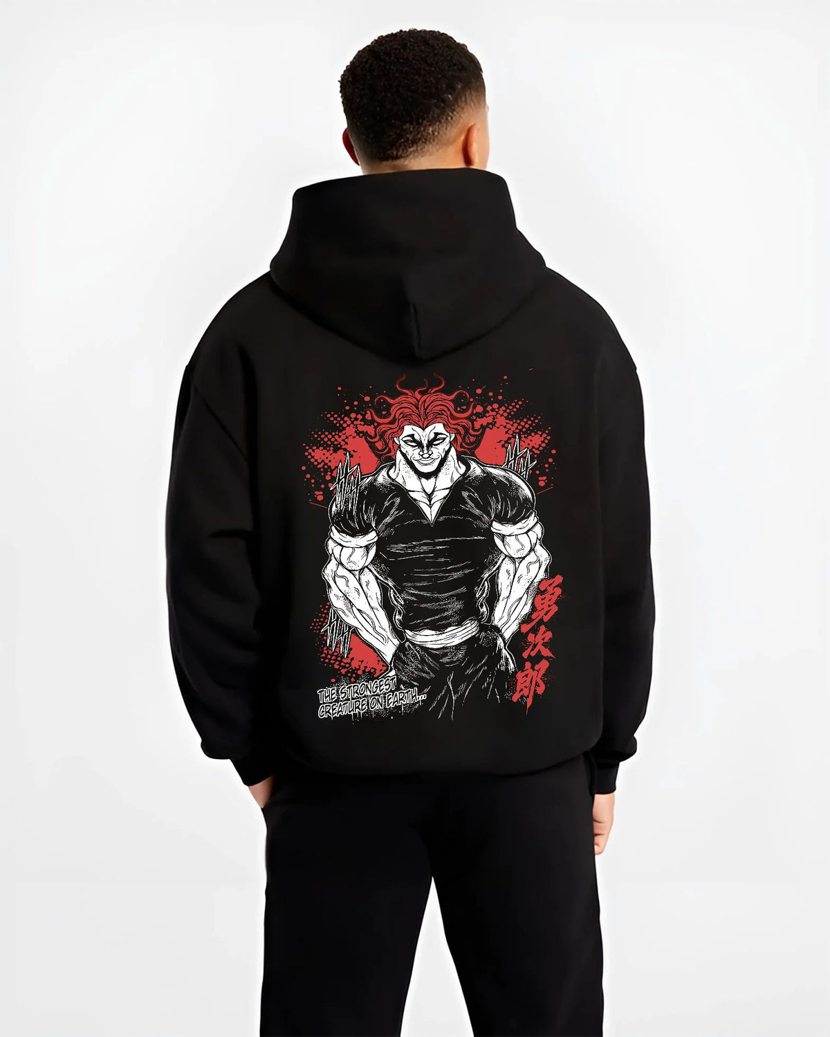 Black hoodie model back view with Yujiro Hanma (muscular, red-haired portrait) from Baki illustrated back graphic