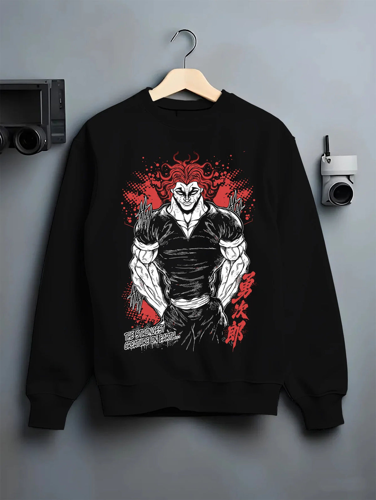 Black crewneck sweatshirt on hanger with Yujiro Hanma (muscular, red-haired portrait) from Baki illustrated back graphic