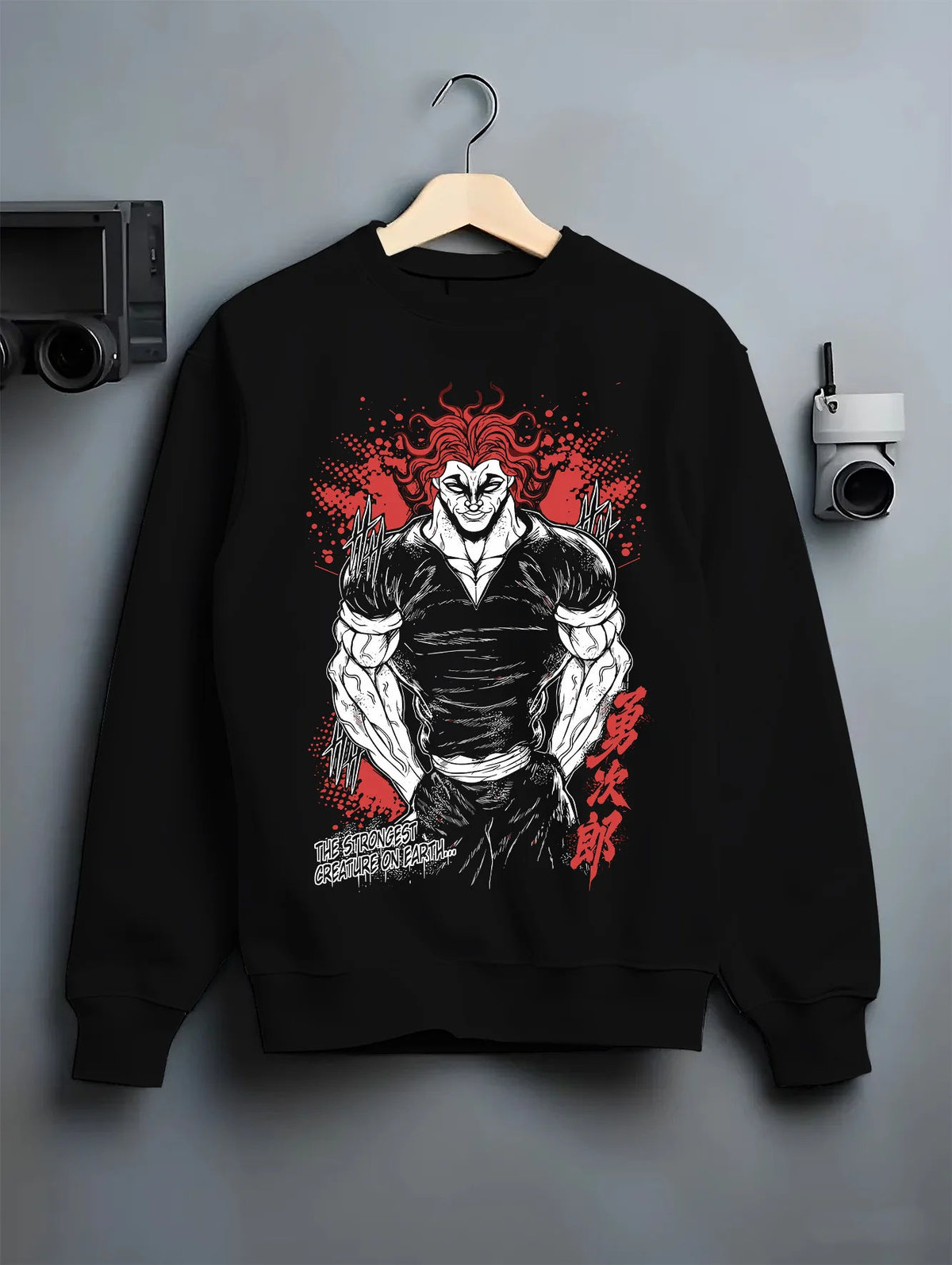 Black crewneck sweatshirt on hanger with Yujiro Hanma (muscular, red-haired portrait) from Baki illustrated back graphic