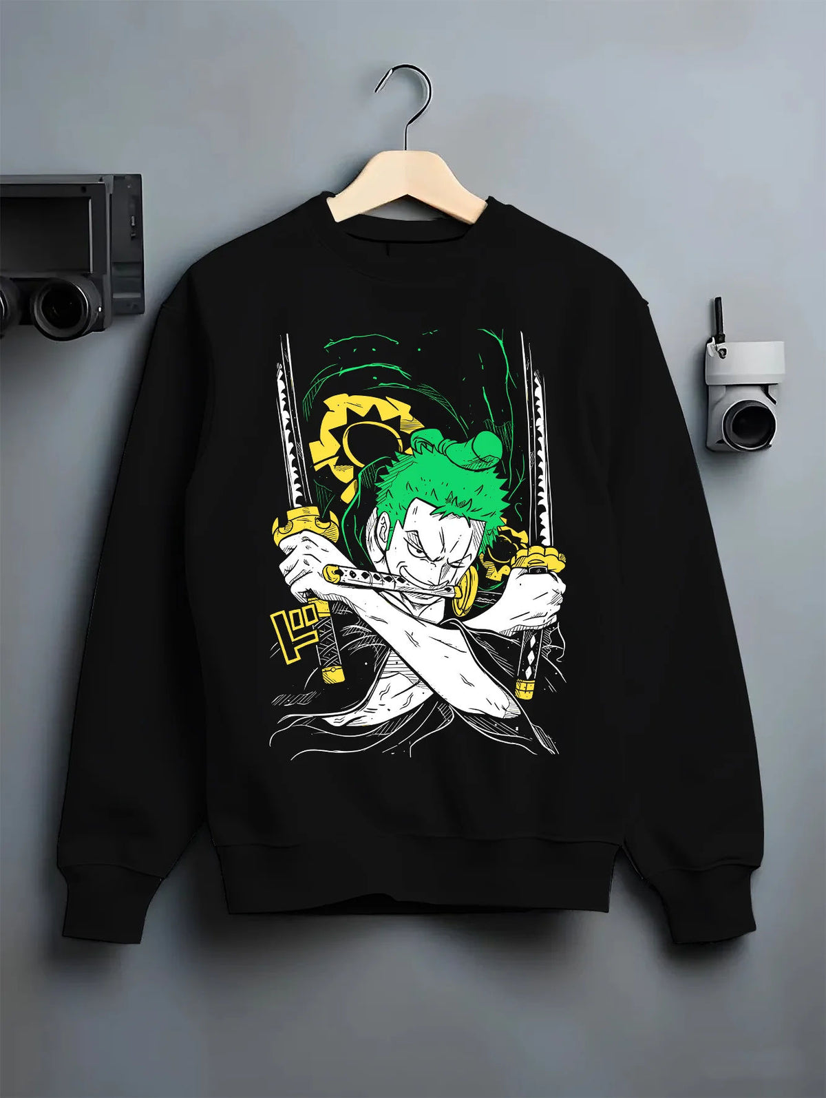 Black crewneck sweatshirt on hanger showing Roronoa Zoro from One Piece: green three-sword crossed-katana artwork