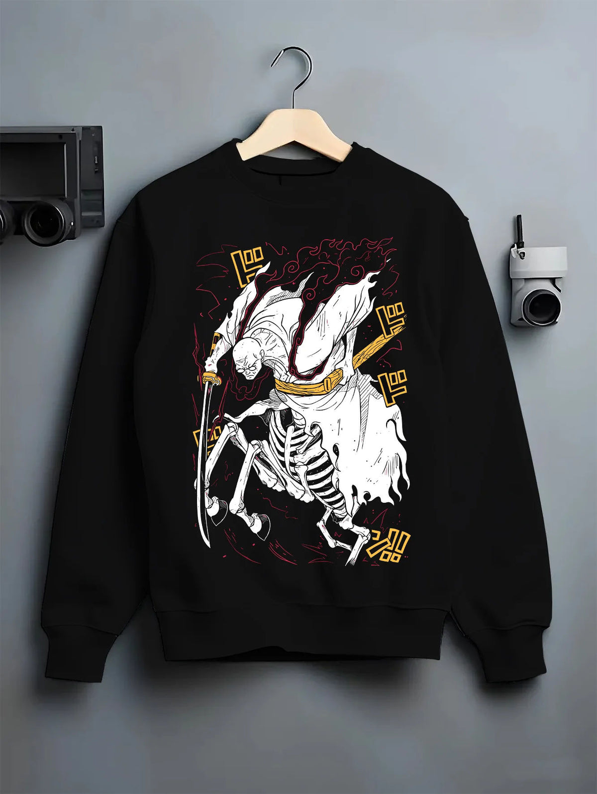 Black crewneck sweatshirt on hanger with Stylised skeleton swordsman with three swords from One Piece illustrated back