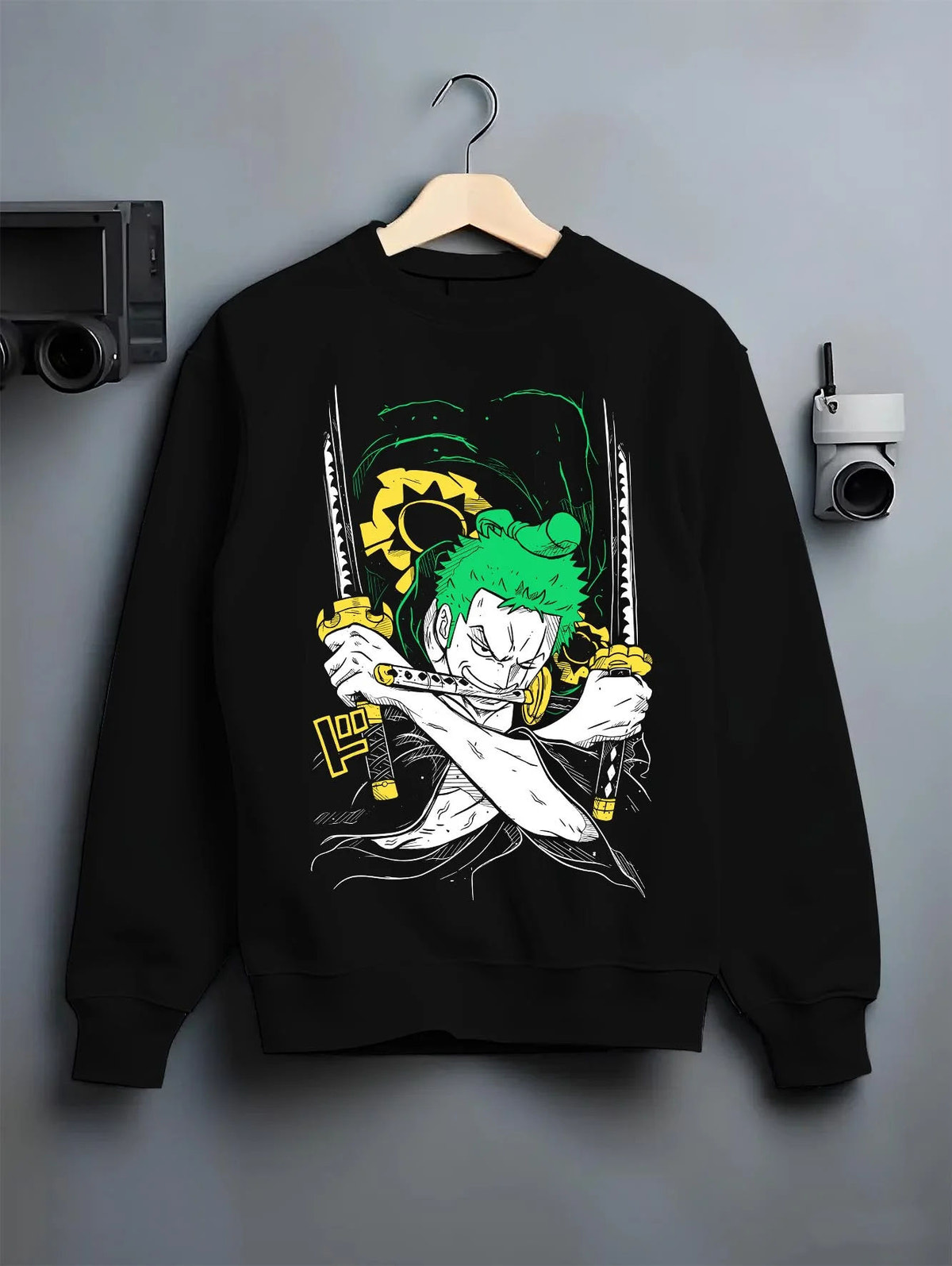 Black crewneck sweatshirt on hanger featuring Roronoa Zoro Santoryu green sword One Piece artwork.