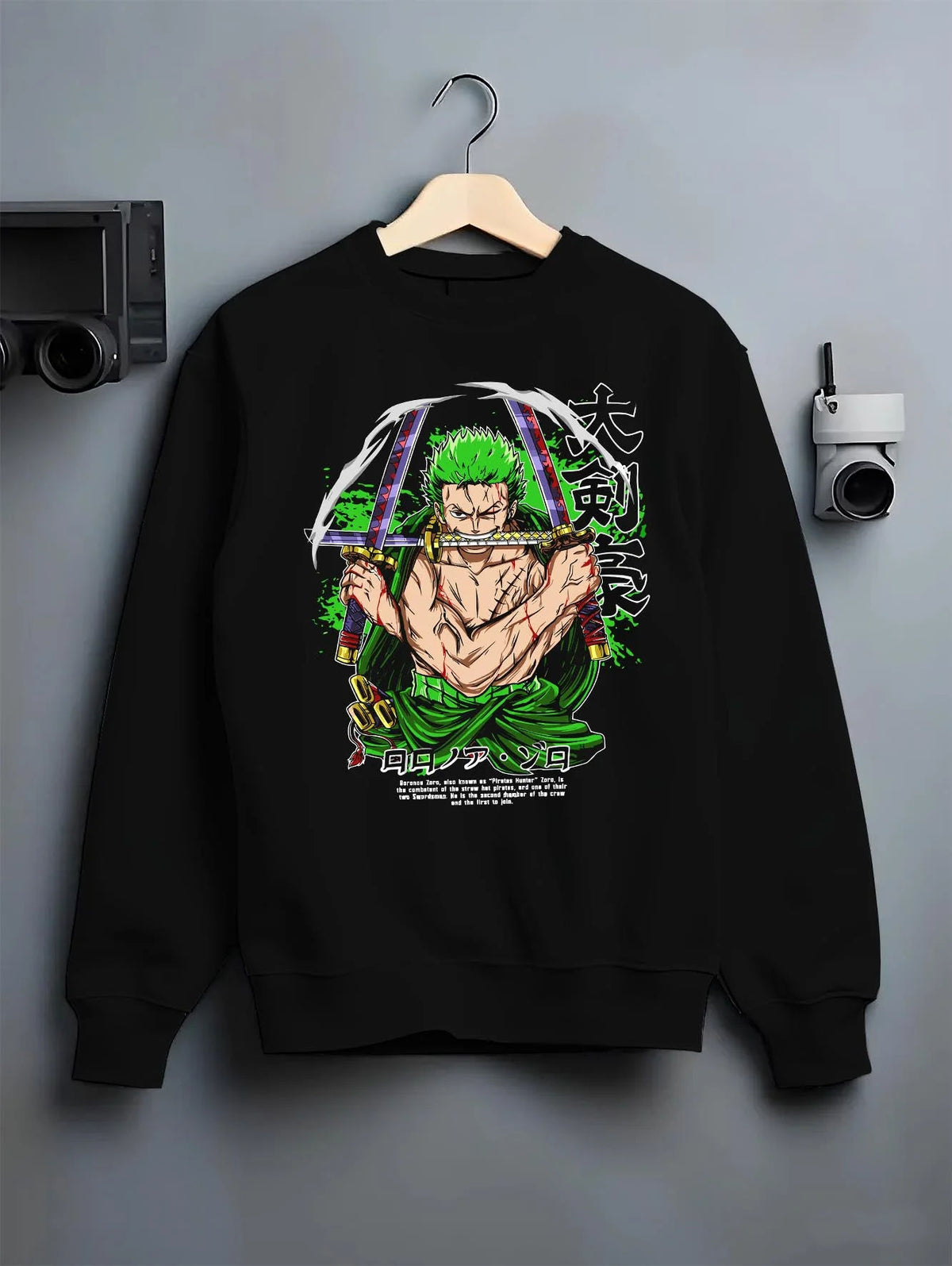 Black crewneck sweatshirt on hanger featuring Roronoa Zoro bandana Three Sword Style One Piece artwork.