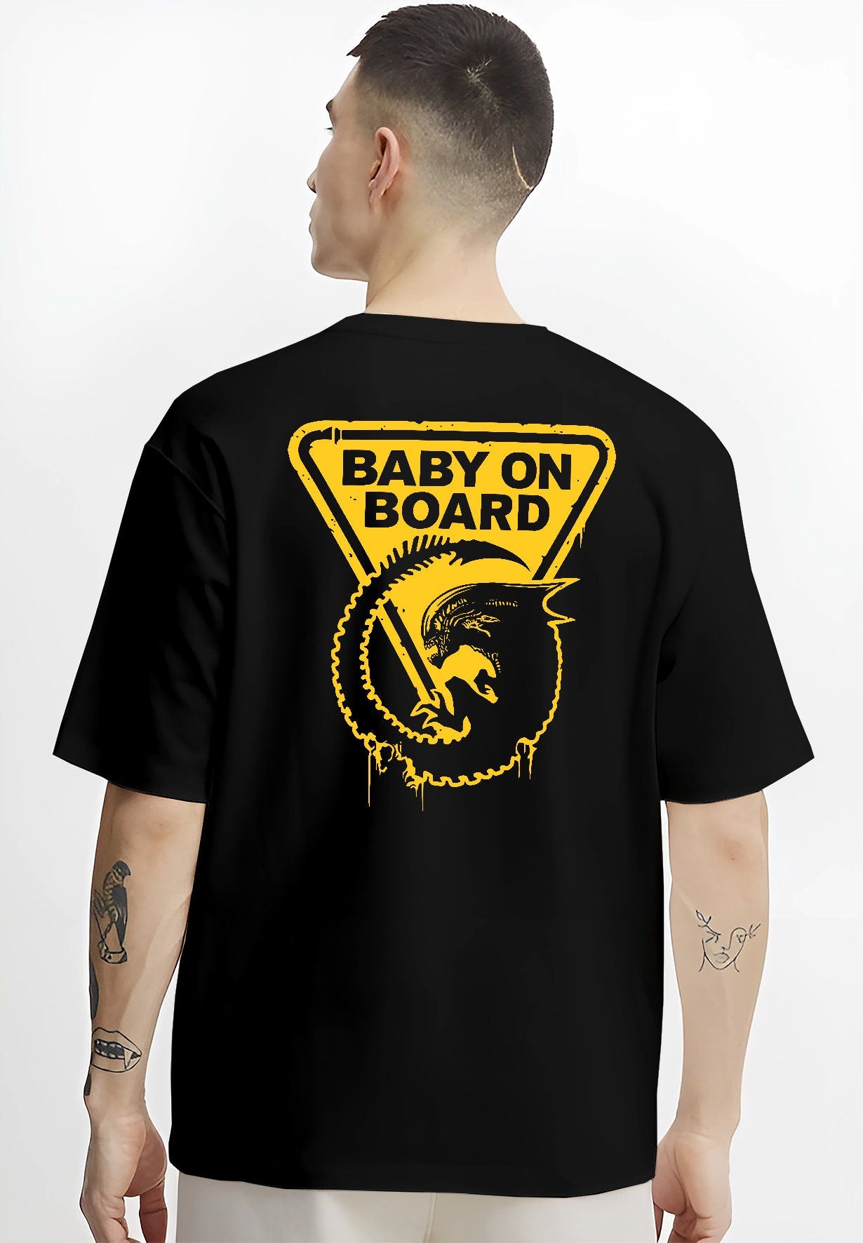 Black hoodie on female model, back view, featuring Alien baby on board triangle sign, distressed edges and dripping yellow details.