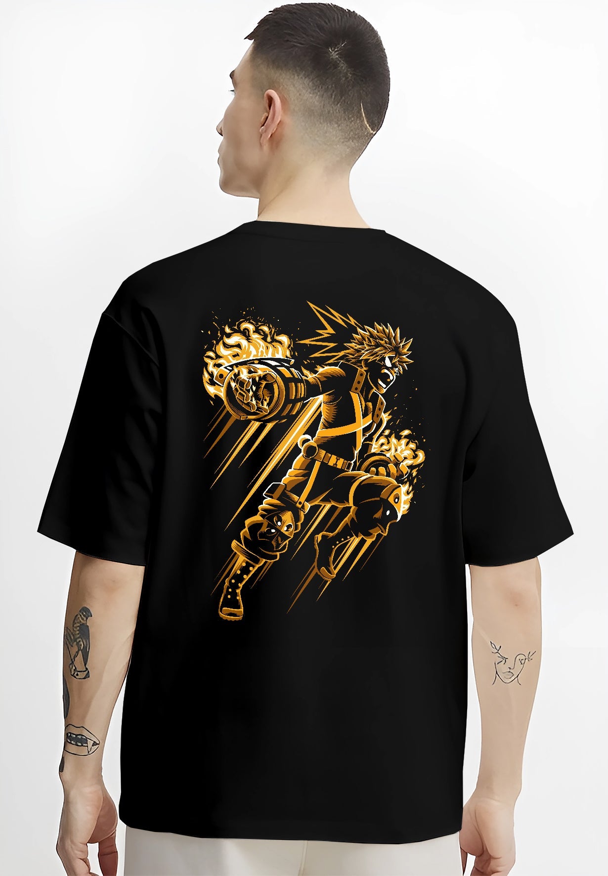 Black T-shirt on male model, back view, Bakugo retro manga artwork showing explosive gauntlets, flame bursts, and dynamic motion lines.