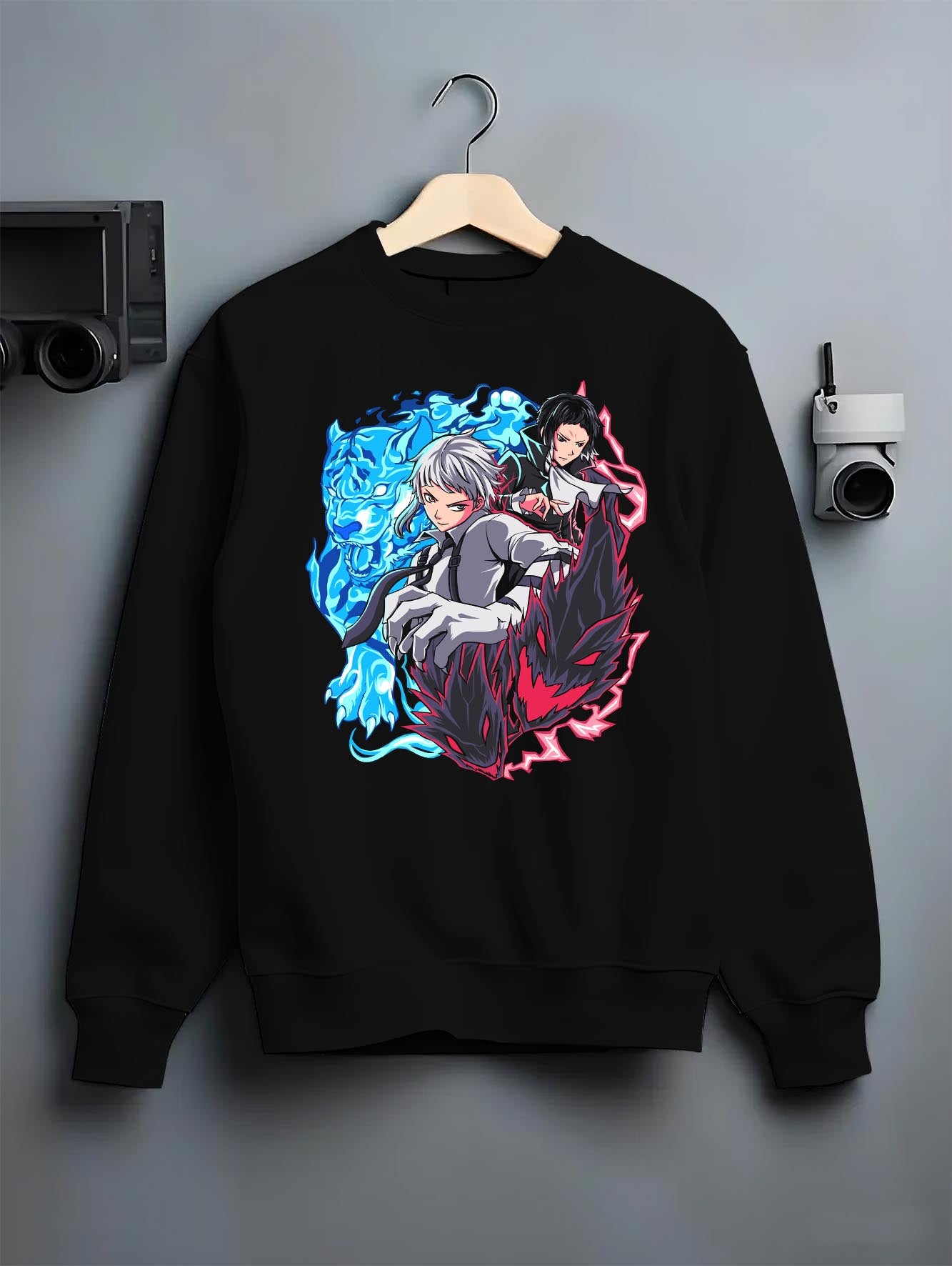 Black crewneck sweatshirt on hanger against grey wall, Bungo Stray Dogs back graphic of Atsushi and Akutagawa with blue tiger and red shadow.