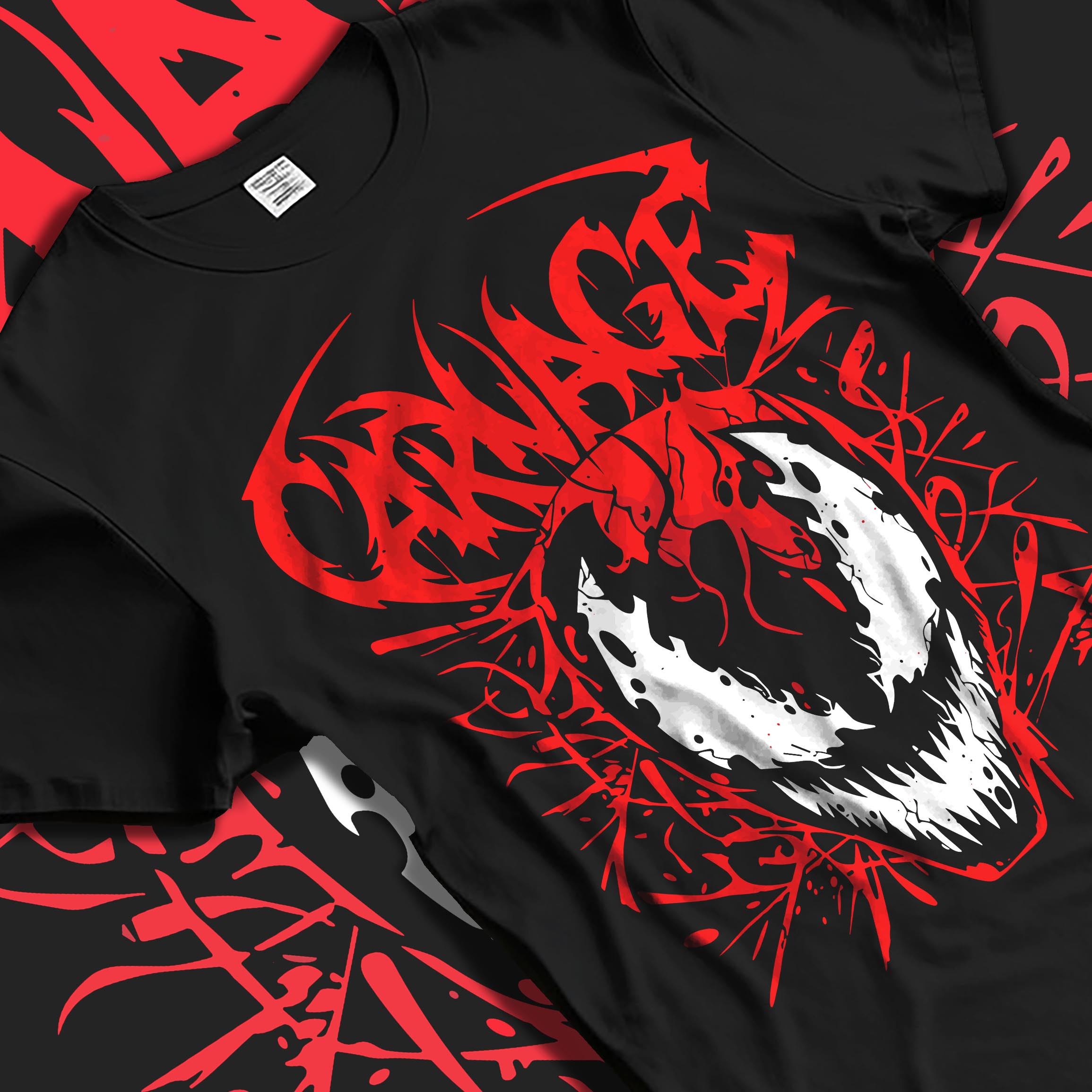 Black T-shirt laid flat with soft folds, featuring Carnage mask graphic ringed by red symbiote tendrils and graffiti title.