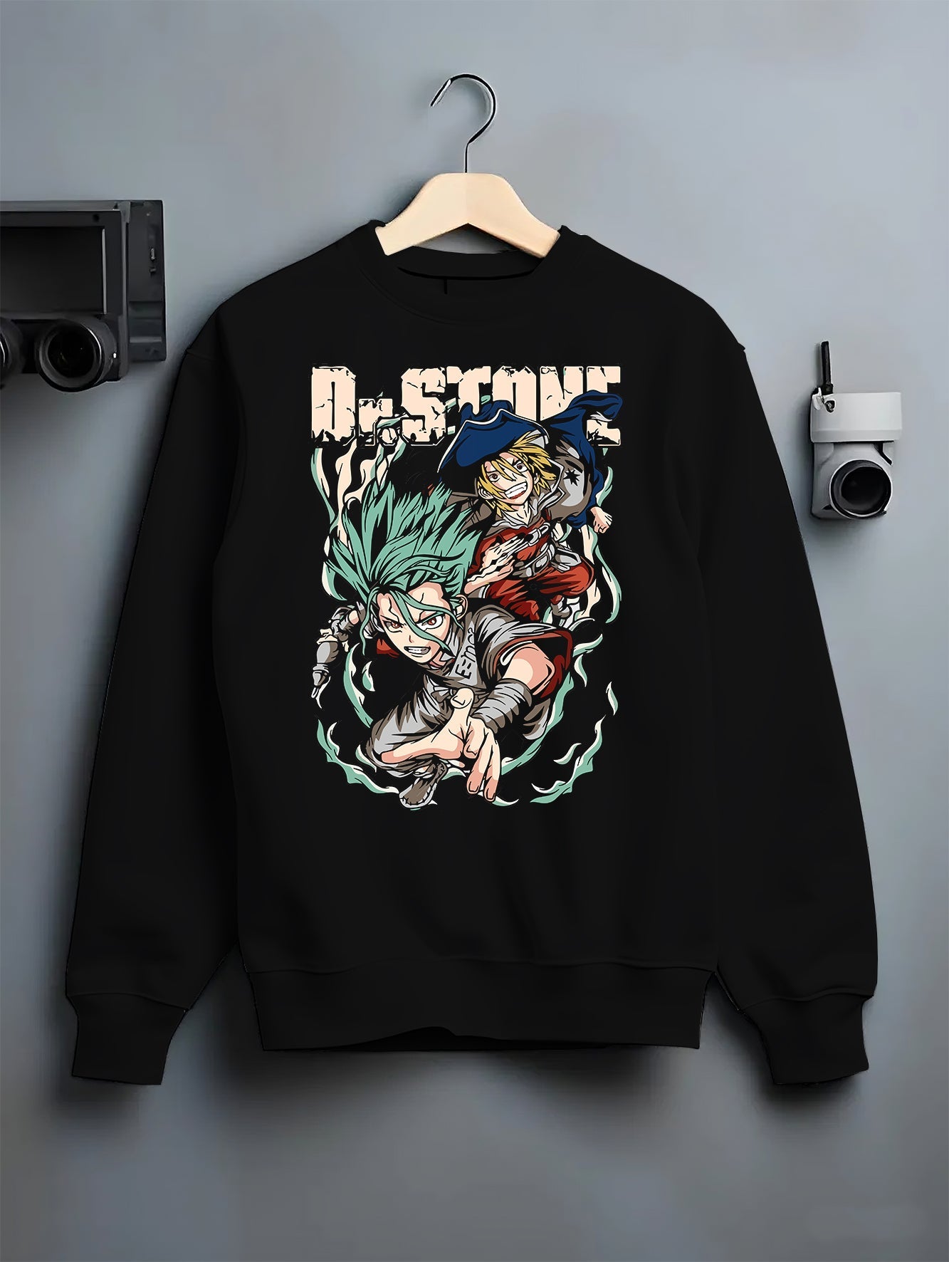 Black crewneck sweatshirt on a hanger against a grey wall, featuring Dr. Stone Senku and Ryusui retro manga back graphic.