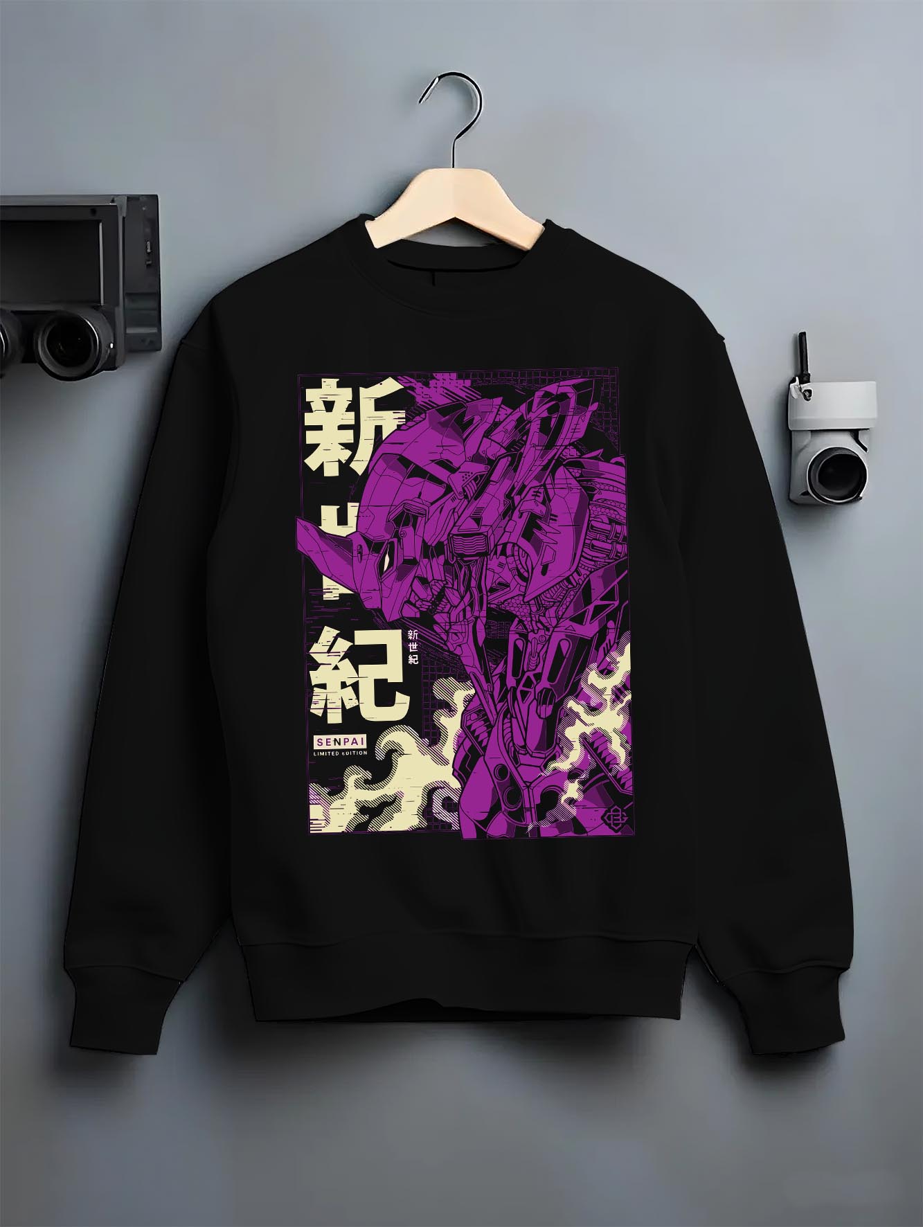 Black crewneck sweatshirt on a hanger against a grey wall, featuring Evangelion Unit-01 retro streetwear graphic with purple mecha silhouette and kanji.
