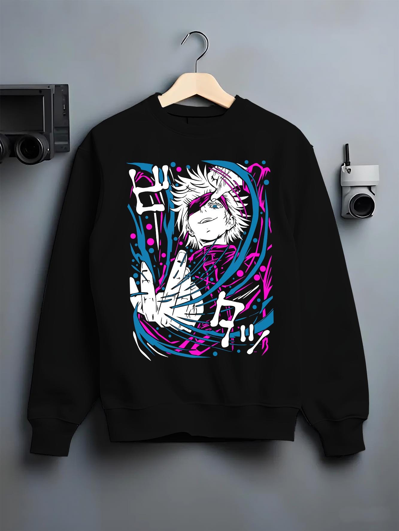 Black crewneck sweatshirt on hanger against grey wall, Gojo anime poster back graphic with bright pink and cyan swirls.