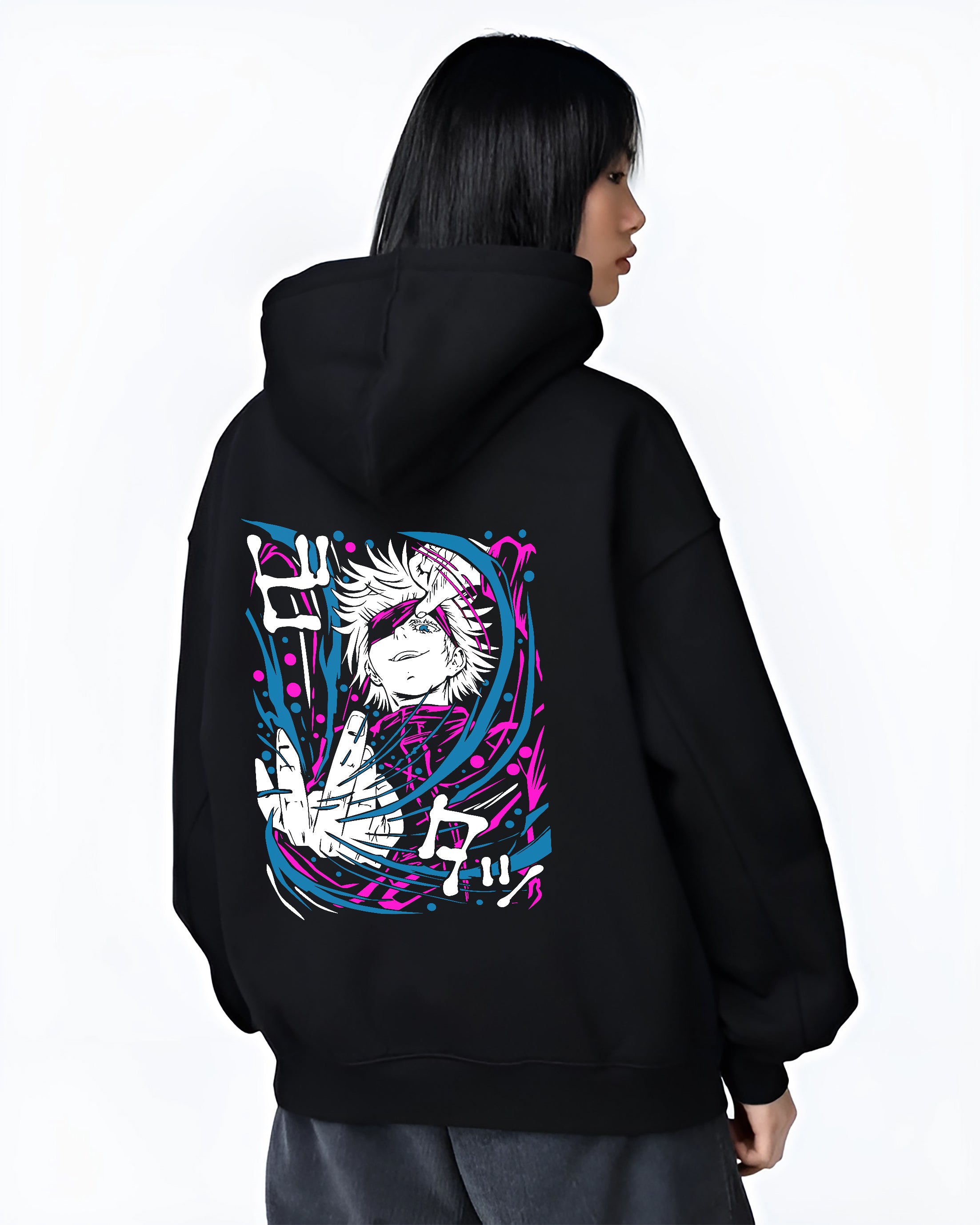 Black hoodie on female model, back view, featuring Gojo retro manga graphic with bold pink and cyan energy ribbons.
