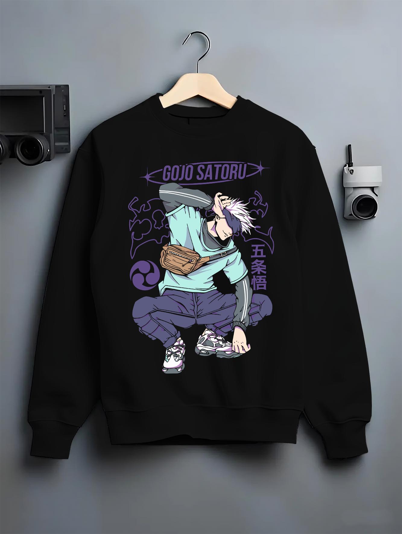 Black crewneck sweatshirt on hanger against grey wall, Gojo Satoru urban fashion back design with purple lettering, dynamic pose and clean manga styling.