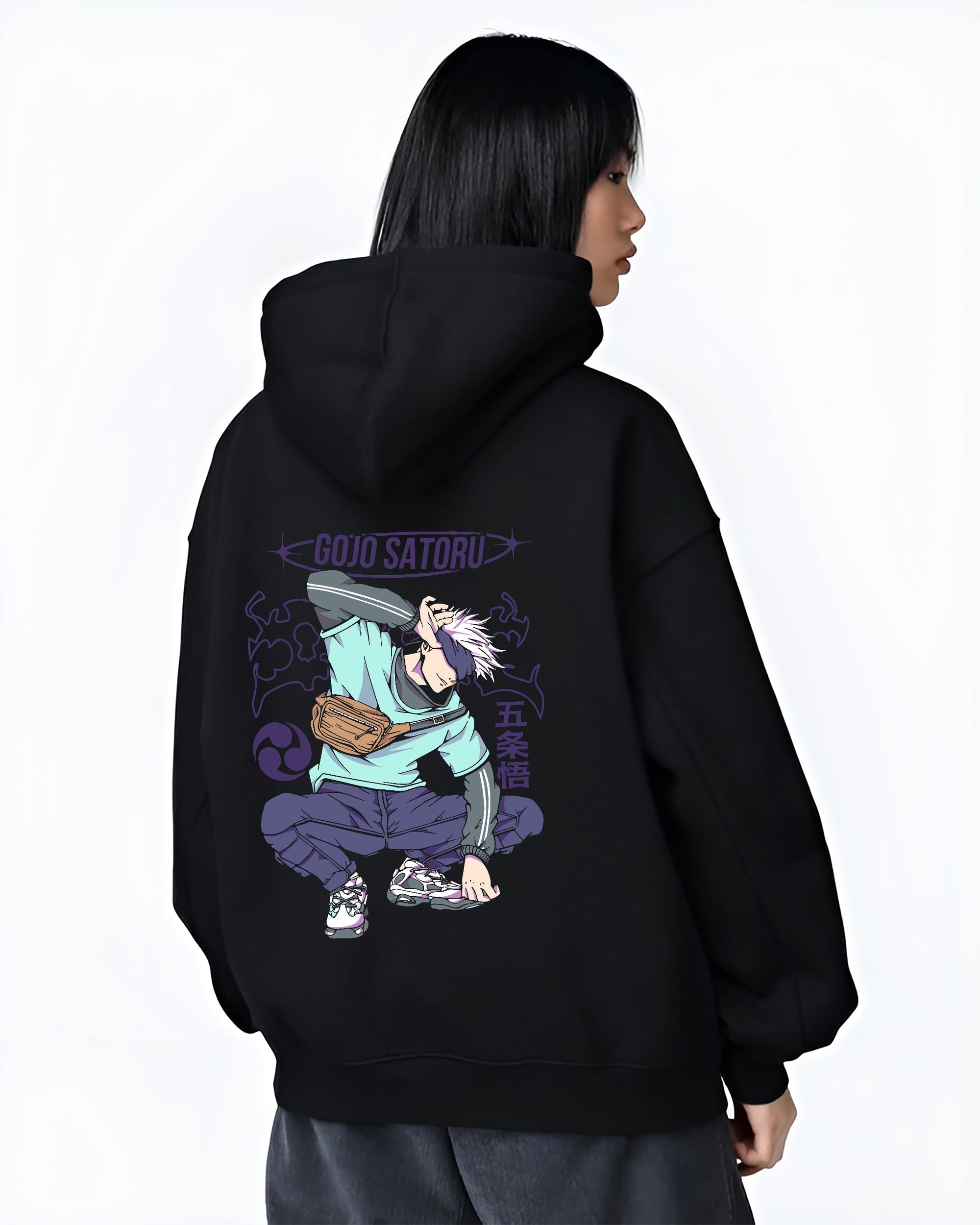 Black hoodie on female model, back view, showcasing Gojo Satoru pose with purple lettering, retro manga graphic lines and clean Japanese streetwear styling.
