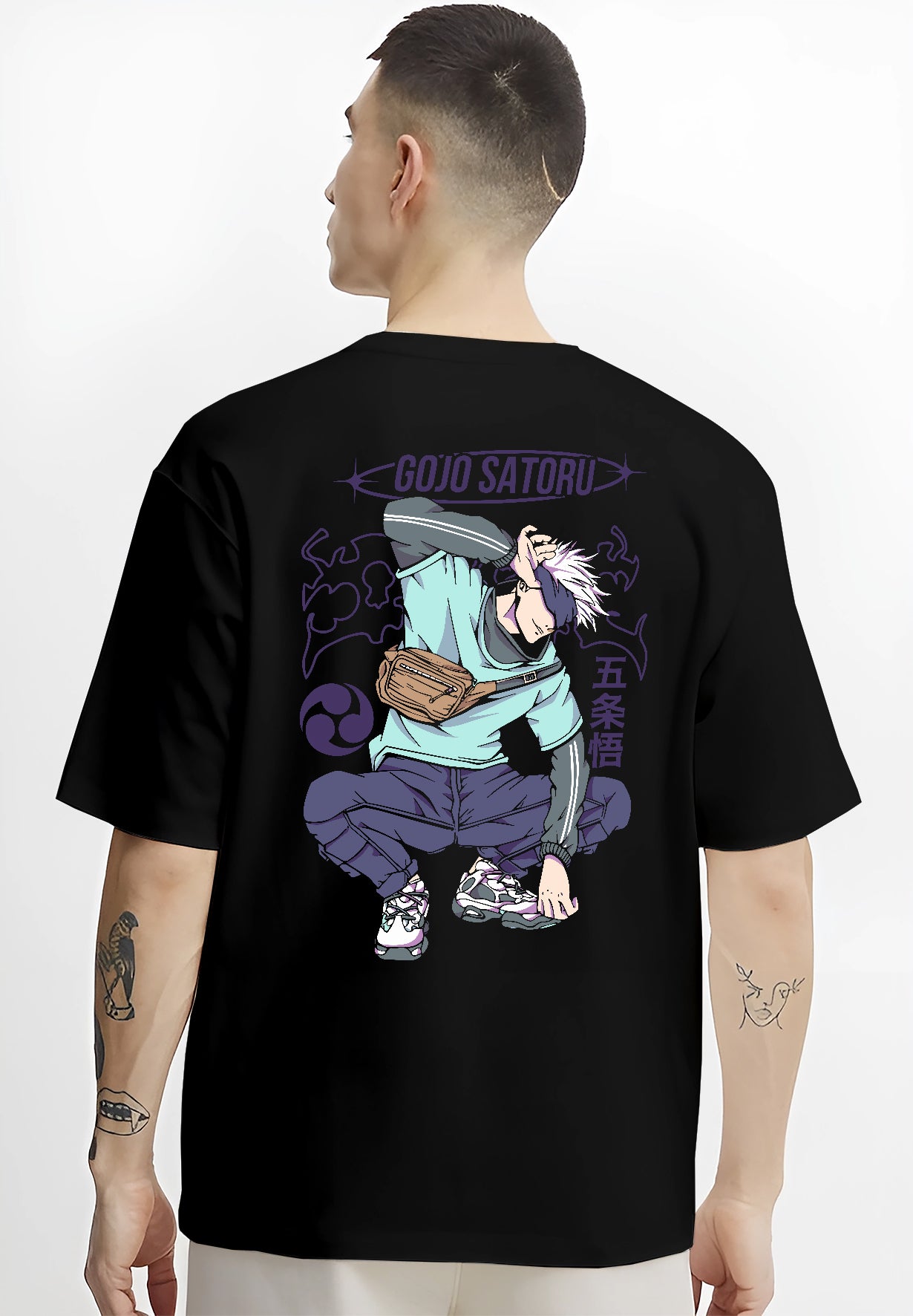 Black T-shirt on male model, back view, featuring Gojo Satoru Japanese animation streetwear design with bold purple elements and dynamic crouched pose.