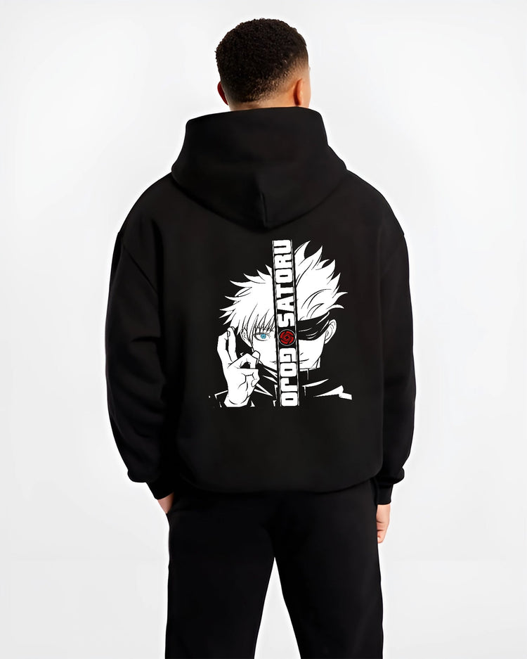Black hoodie on male model, back view, featuring Gojo Satoru split portrait retro manga graphic with blue eye and urban streetwear flair.