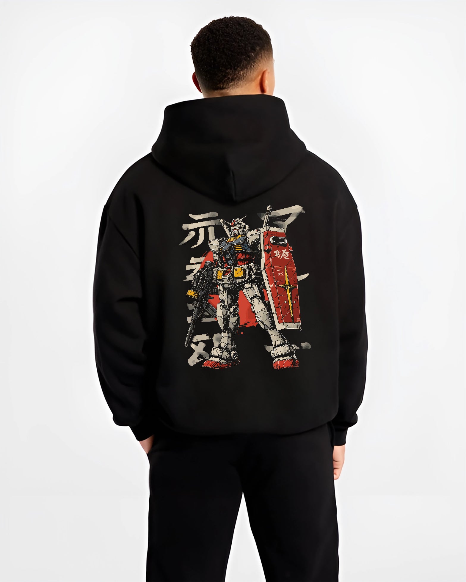Black hoodie worn by a male model, back view, featuring Gundam retro manga graphic with detailed mecha suit, large shield, and Japanese animation streetwear design.