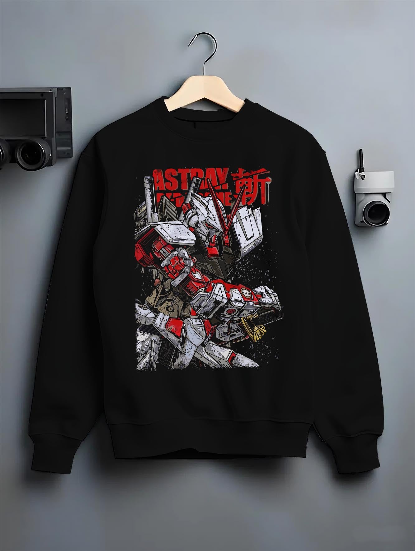 Black crewneck sweatshirt on a hanger against a grey wall, featuring Gundam Astray Red Frame anime poster inspired retro mecha back design in red and grey