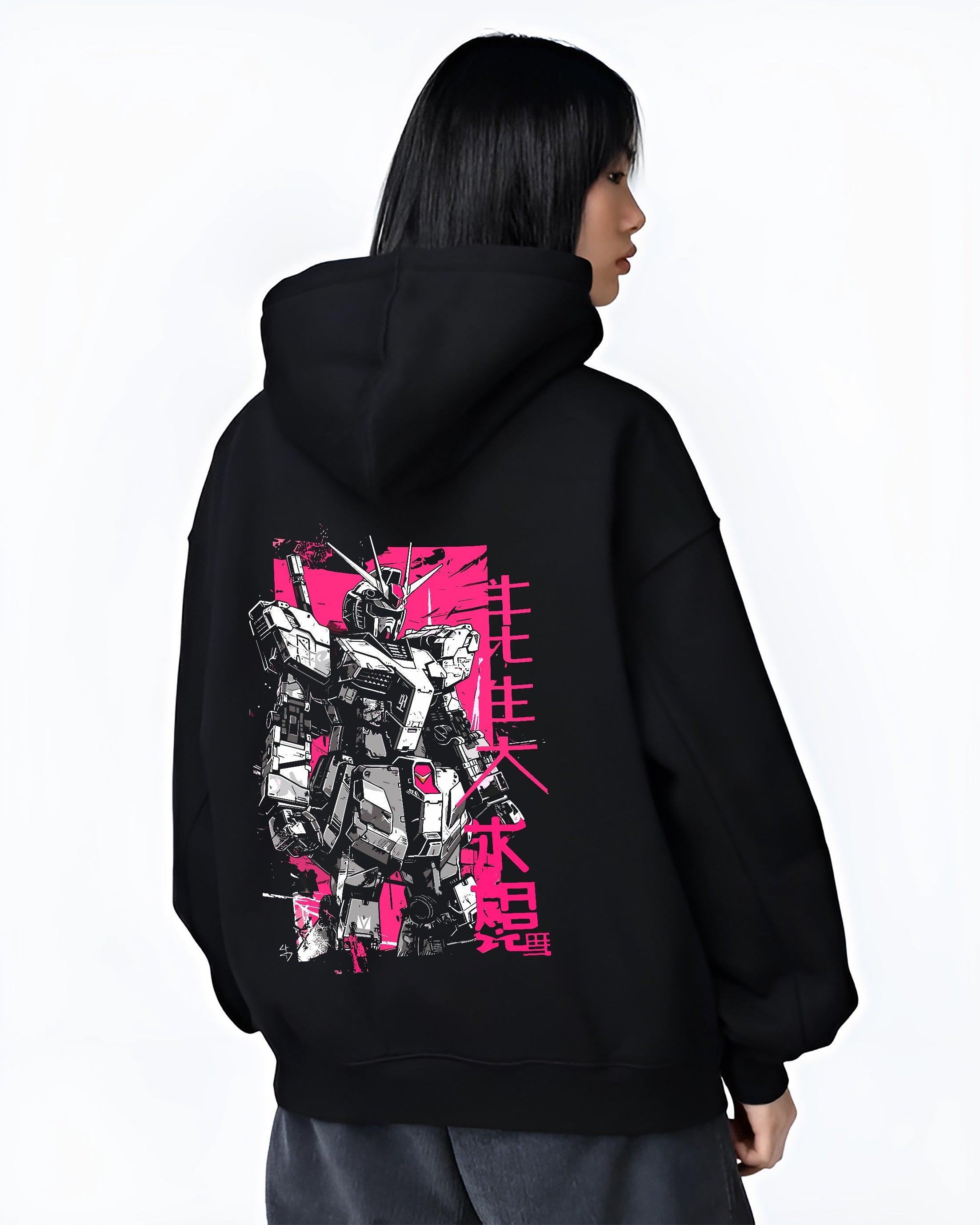 Black hoodie on female model, back view, featuring Gundam retro manga graphic with pink block background and stylised Japanese text.