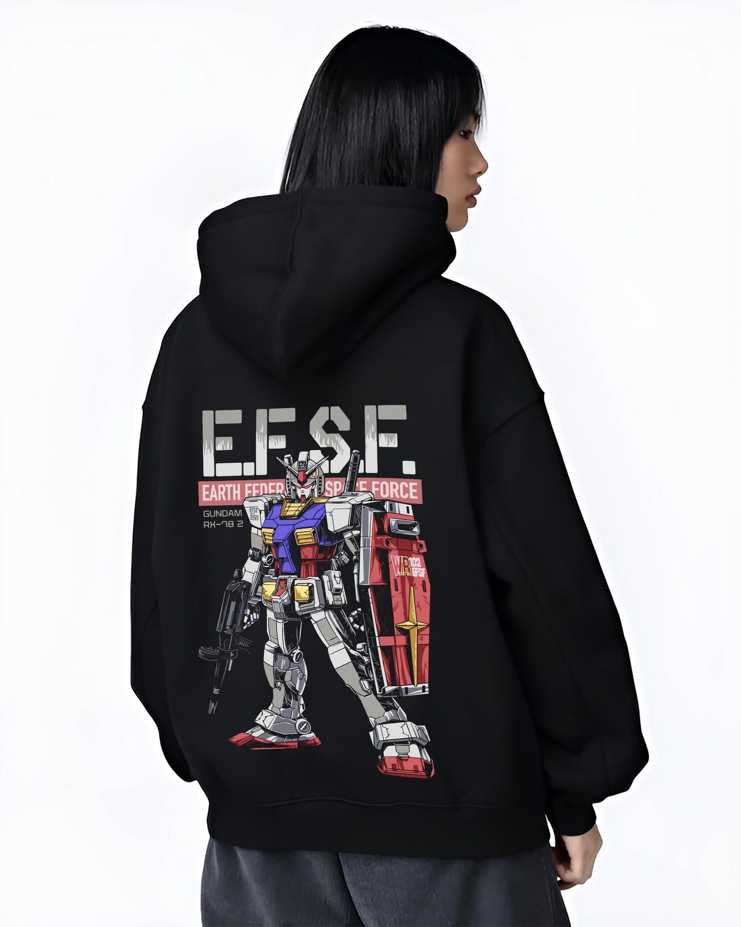 Black hoodie on female model, back view, showing Gundam RX-78-2 retro manga graphic with EFSF typography, red shield, and rifle.