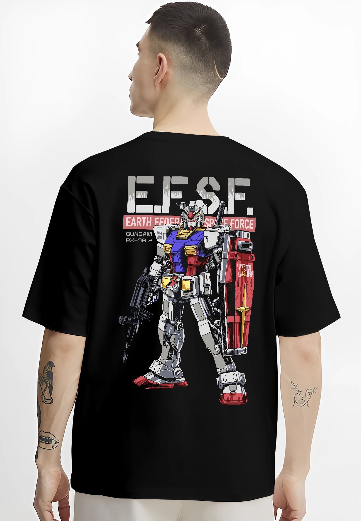 Black T-shirt on male model, back view, featuring Gundam RX-78-2 retro mecha graphic with bold EFSF type, shield, and rifle.